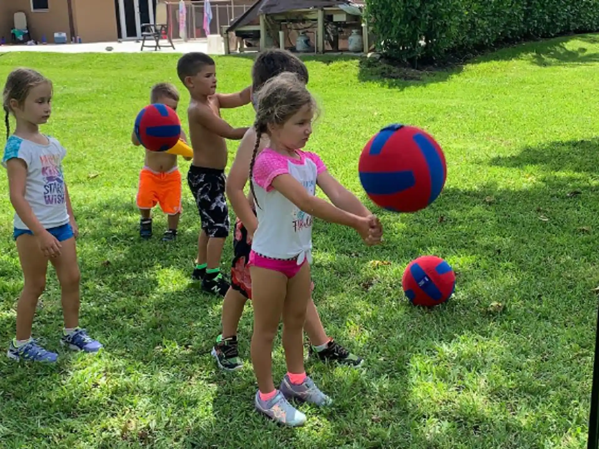 a group of children playing with balls