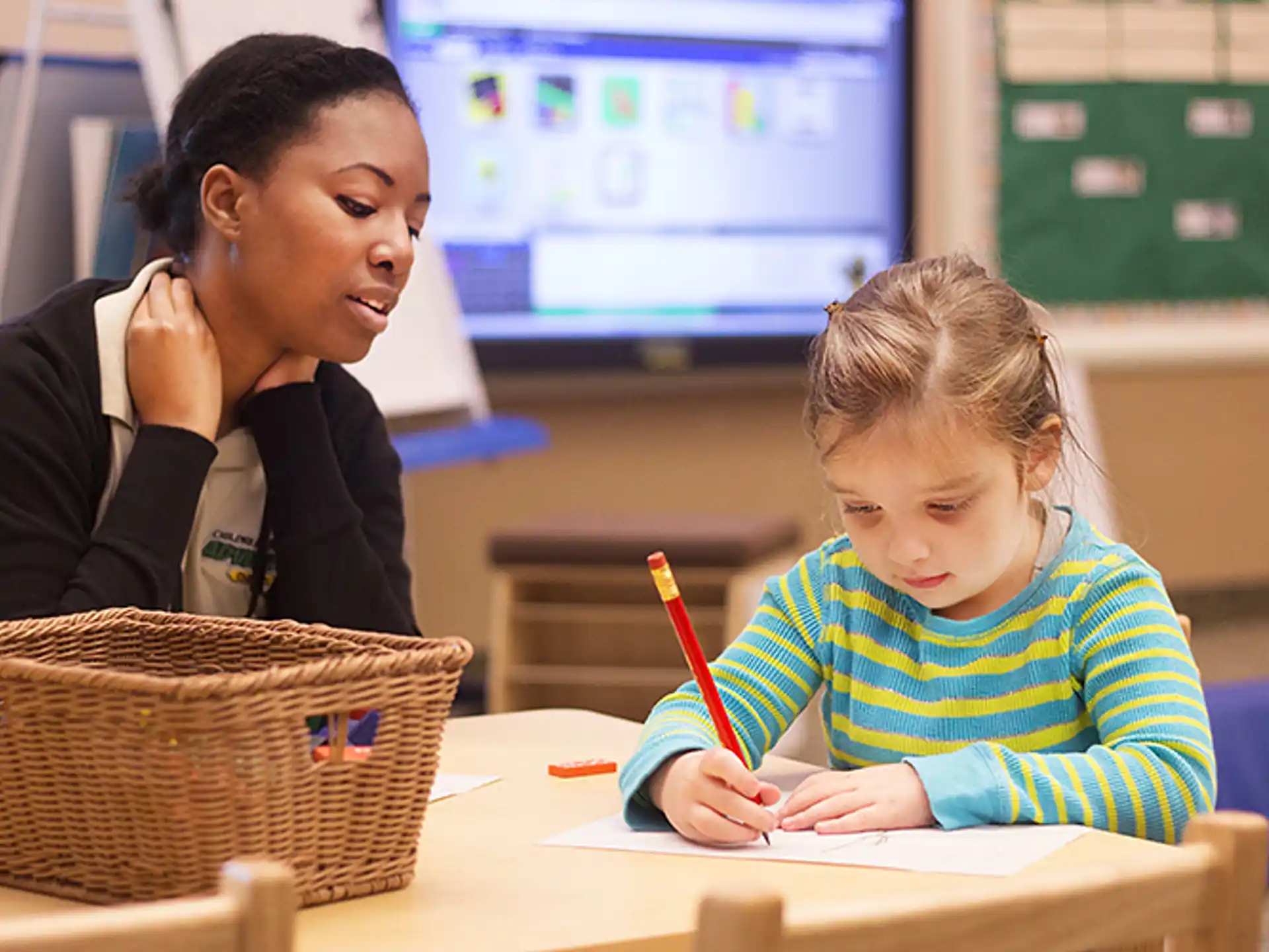 a person and a child sitting at a table
