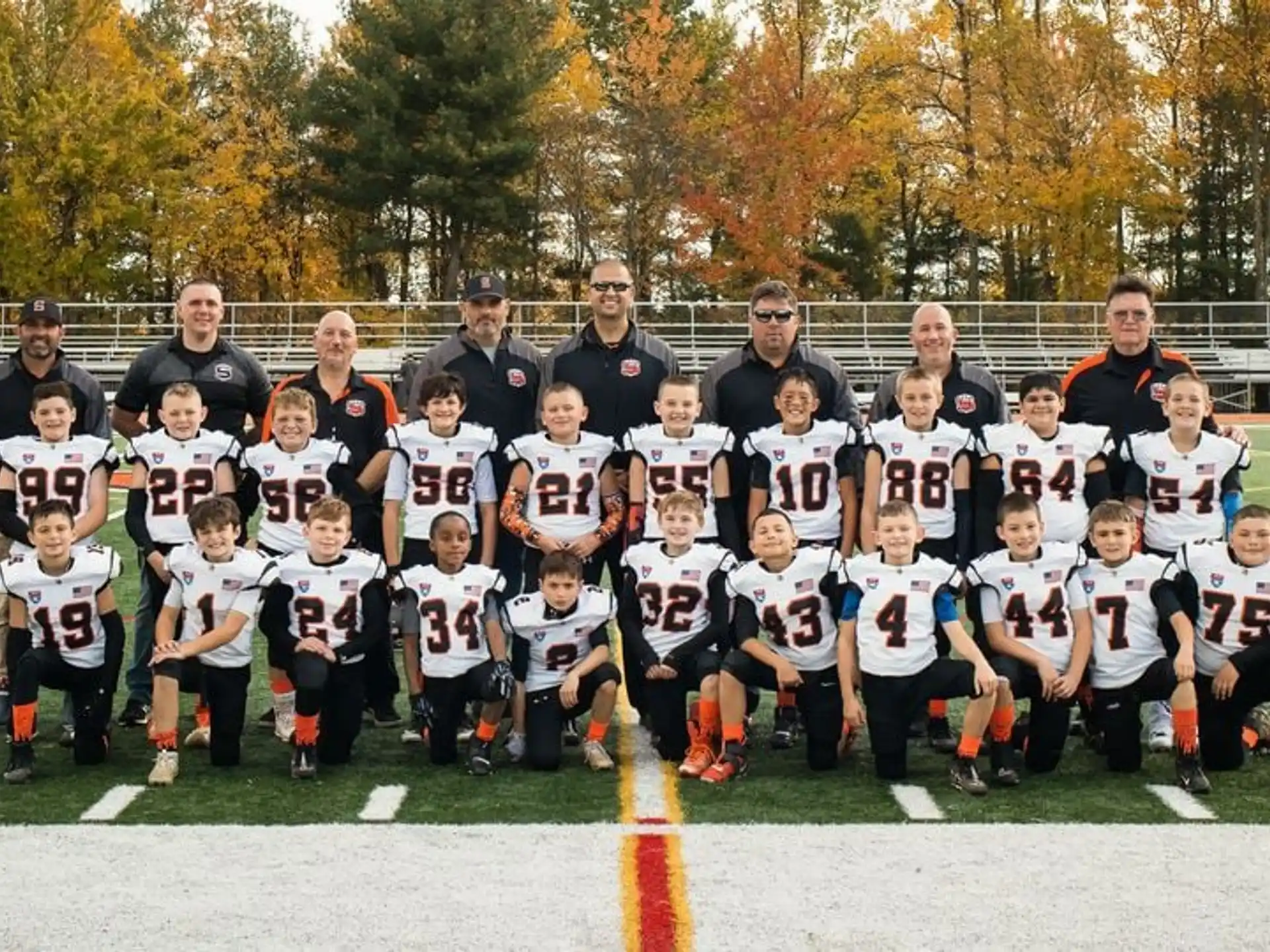 a group of people posing for a photo on a field