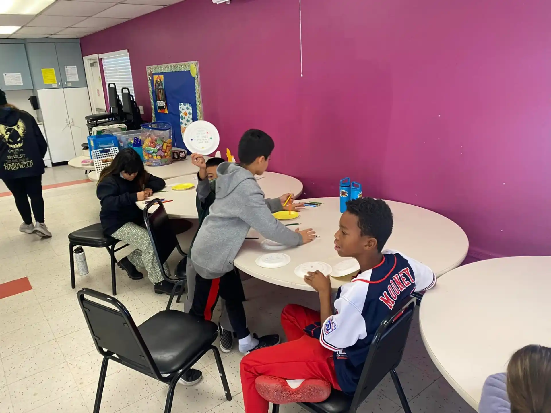 a group of people sitting around a table eating food