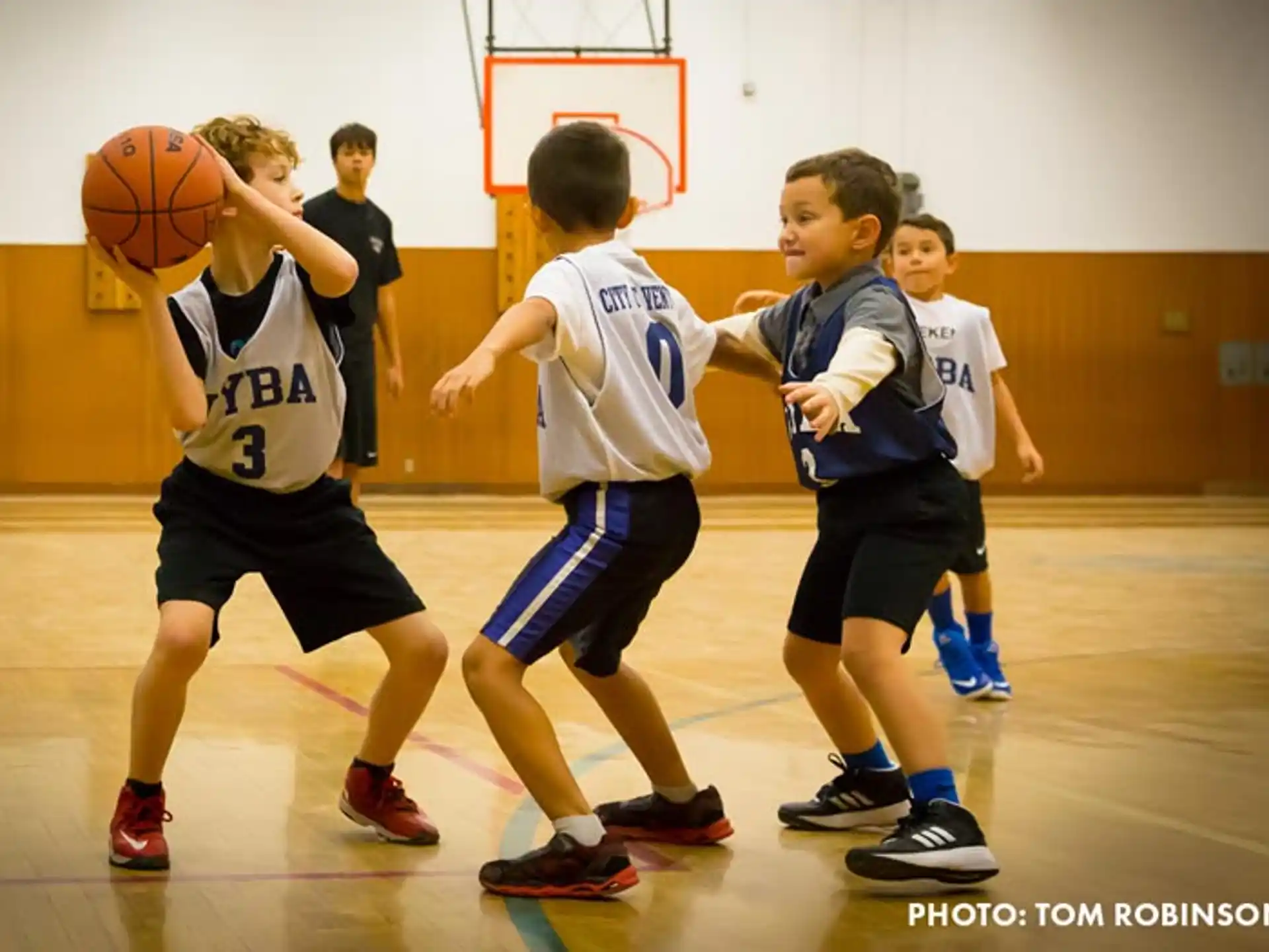 a group of kids playing basketball