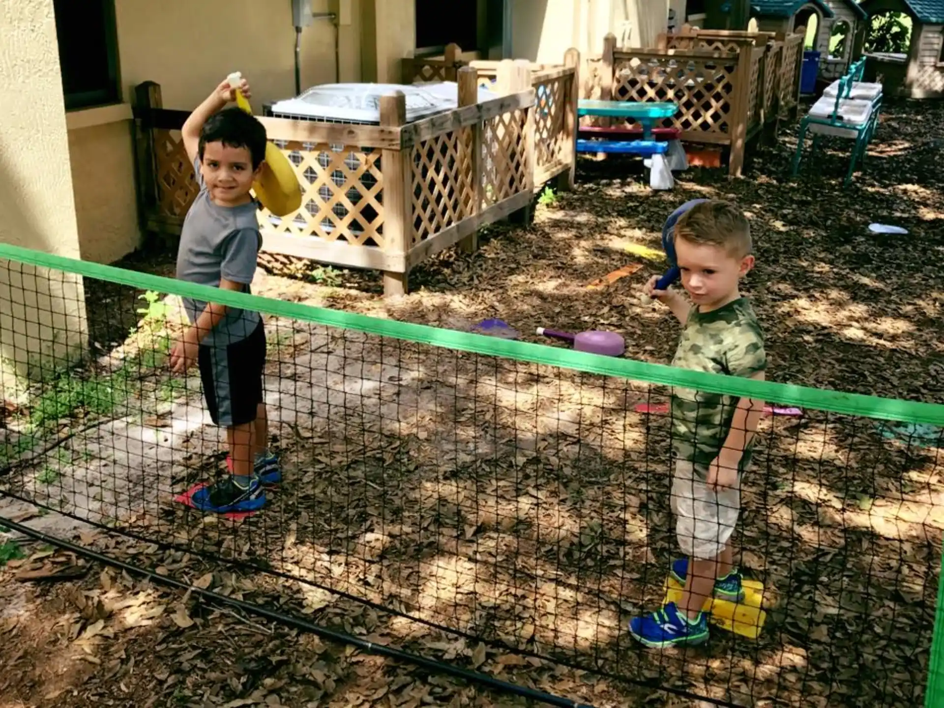 a couple of kids playing in a backyard