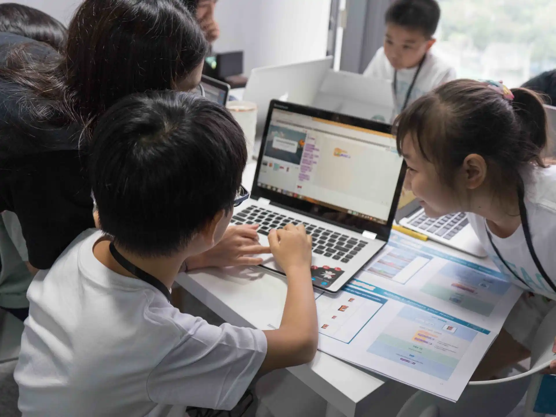 a group of people working on a laptop