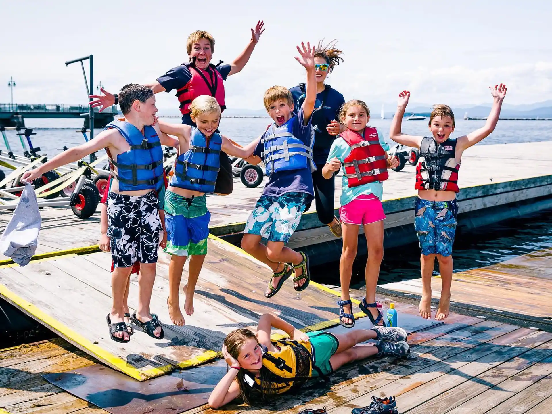 a group of kids posing for a photo on a dock