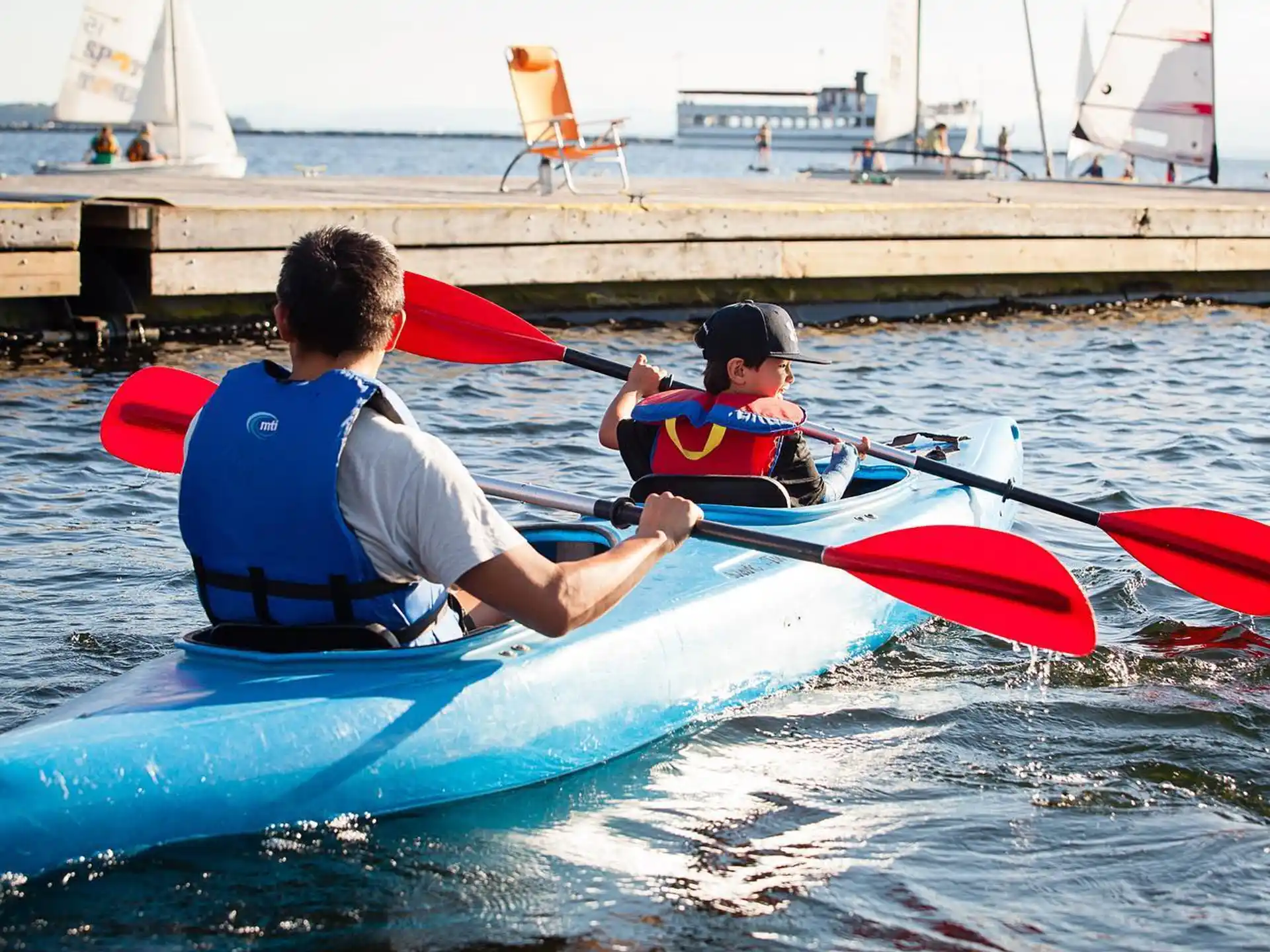 a man and a boy in a kayak on a body of water