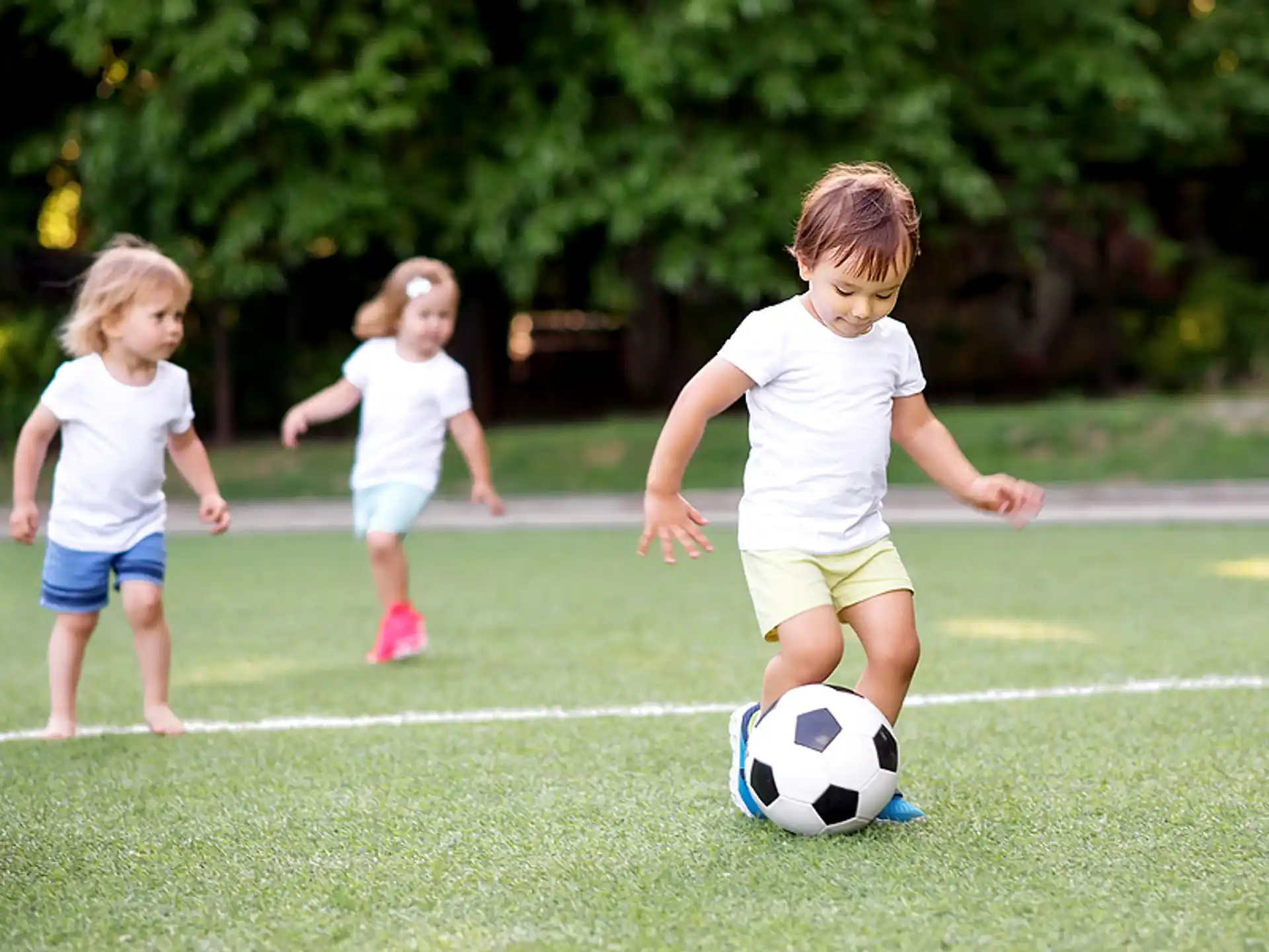 a group of kids playing football
