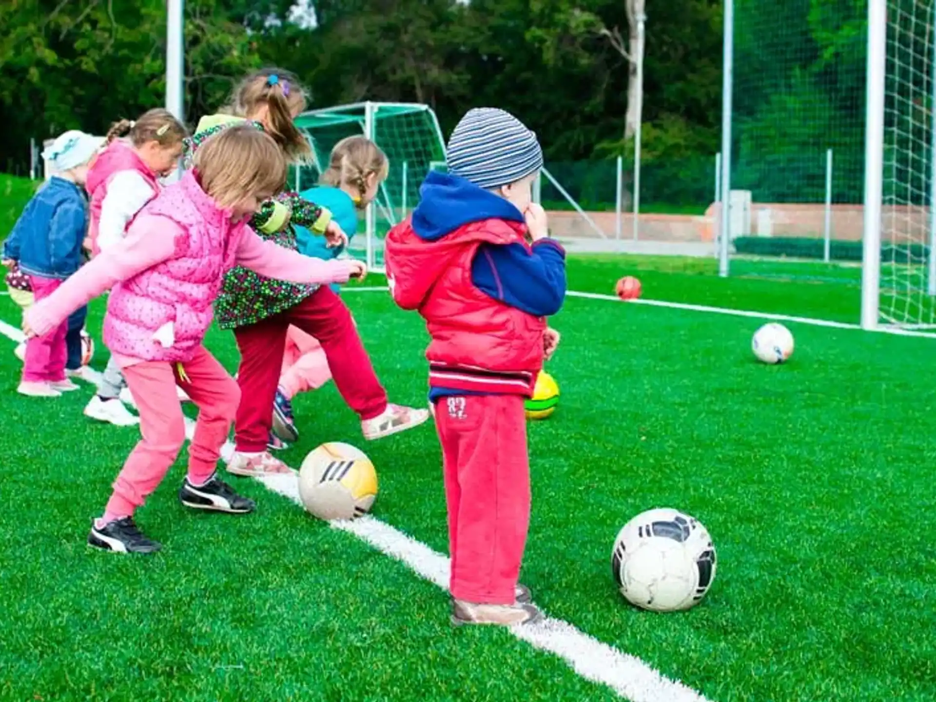 kids playing with football balls