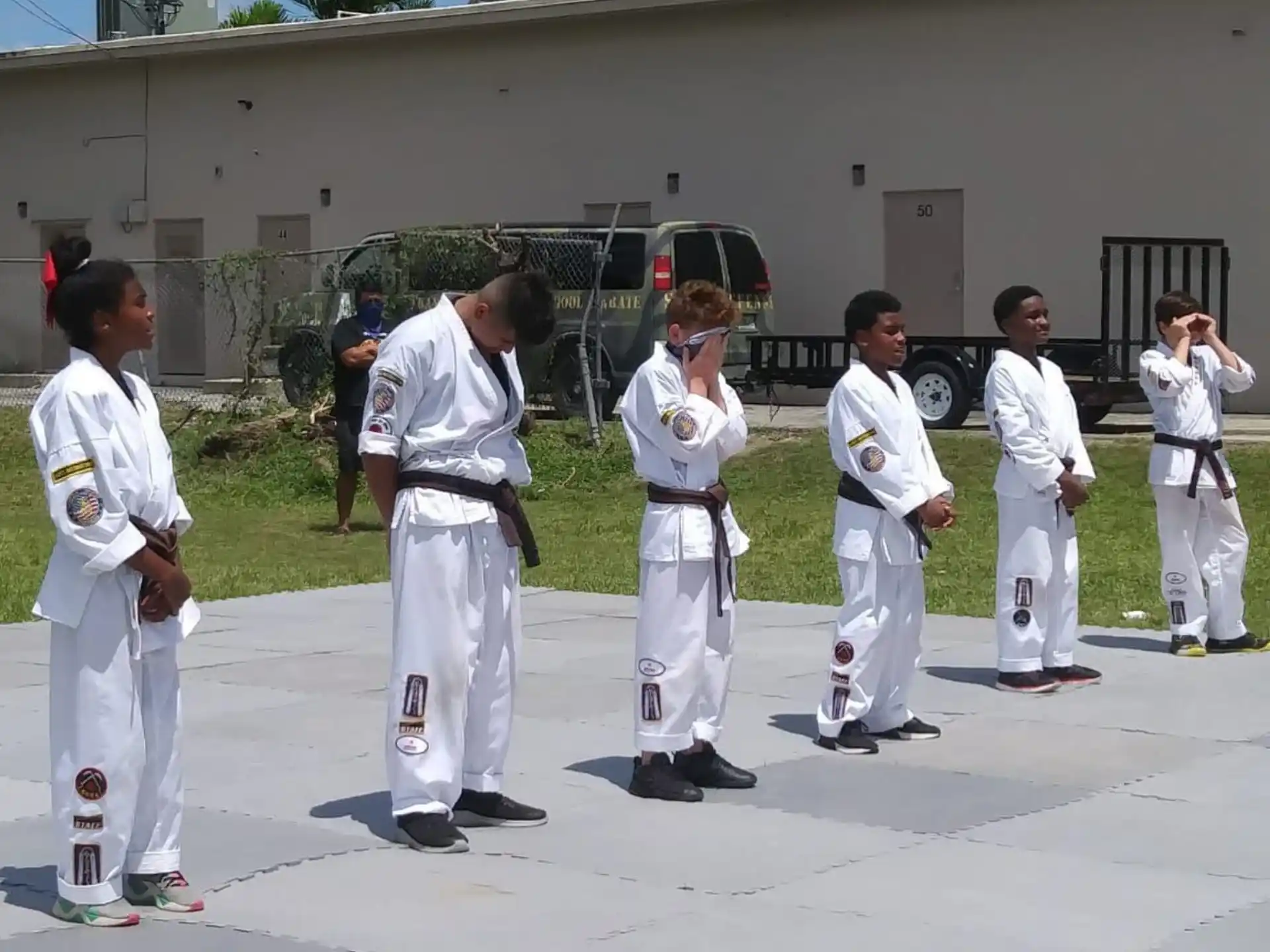 a group of people in white karate uniforms