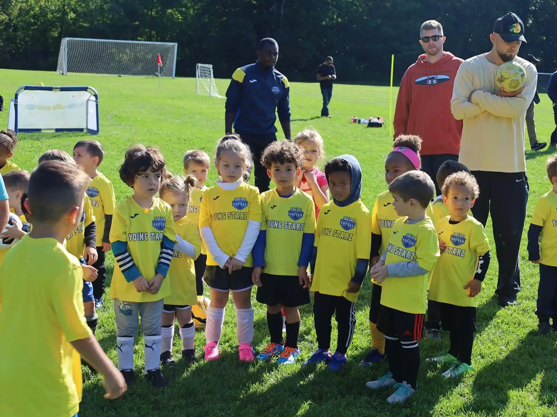 a group of children in yellow shirts
