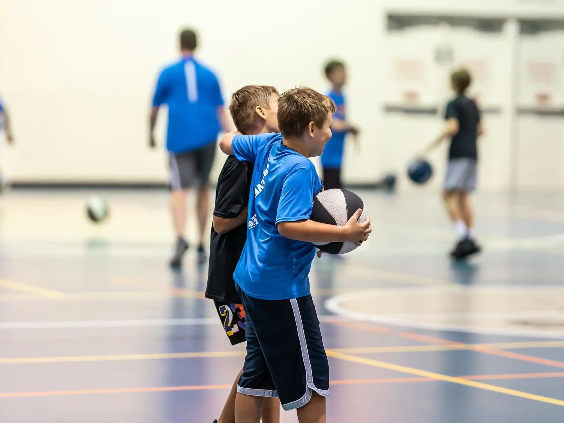 a couple of boys playing basketball