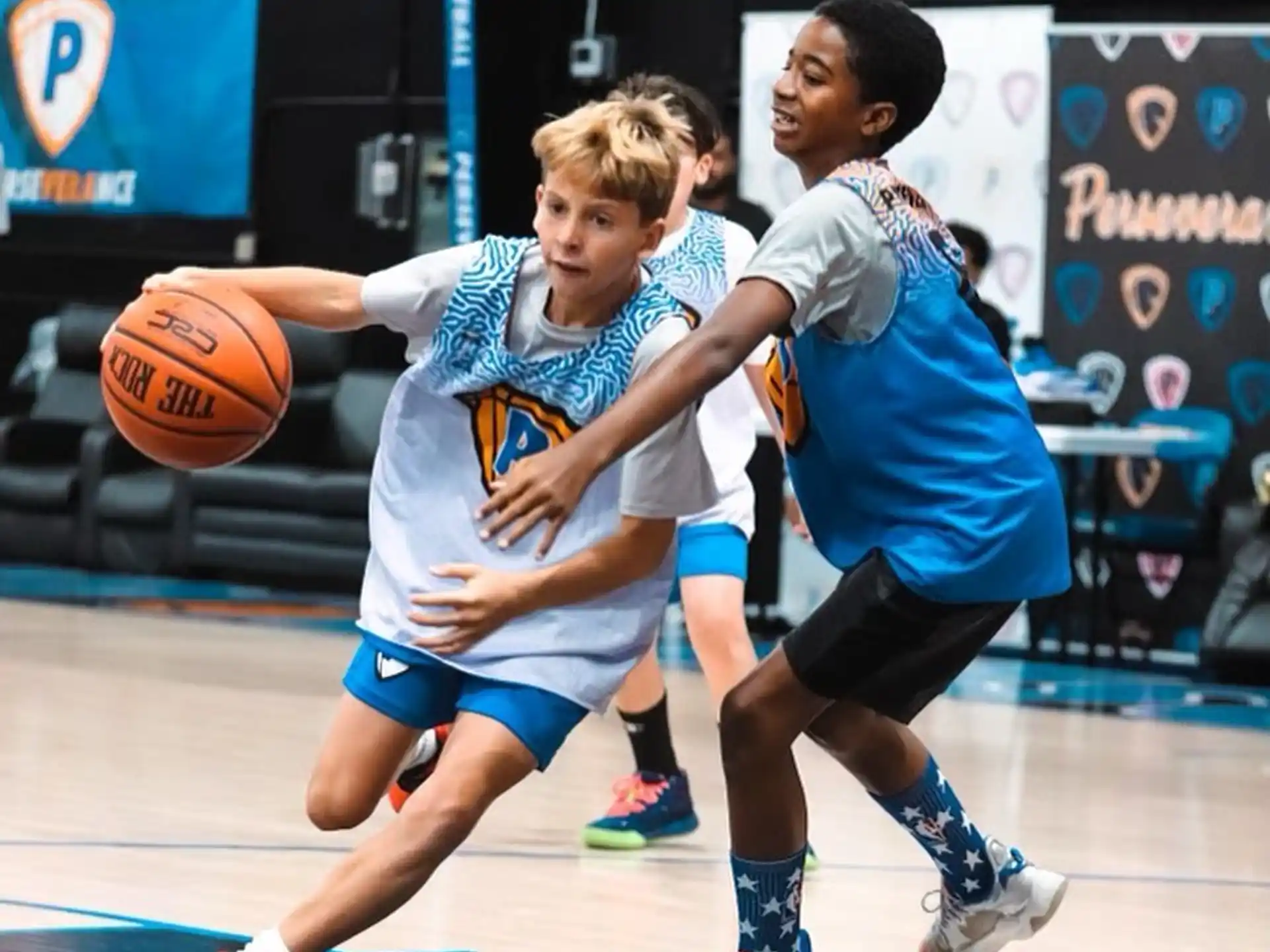 a couple of people playing basketball