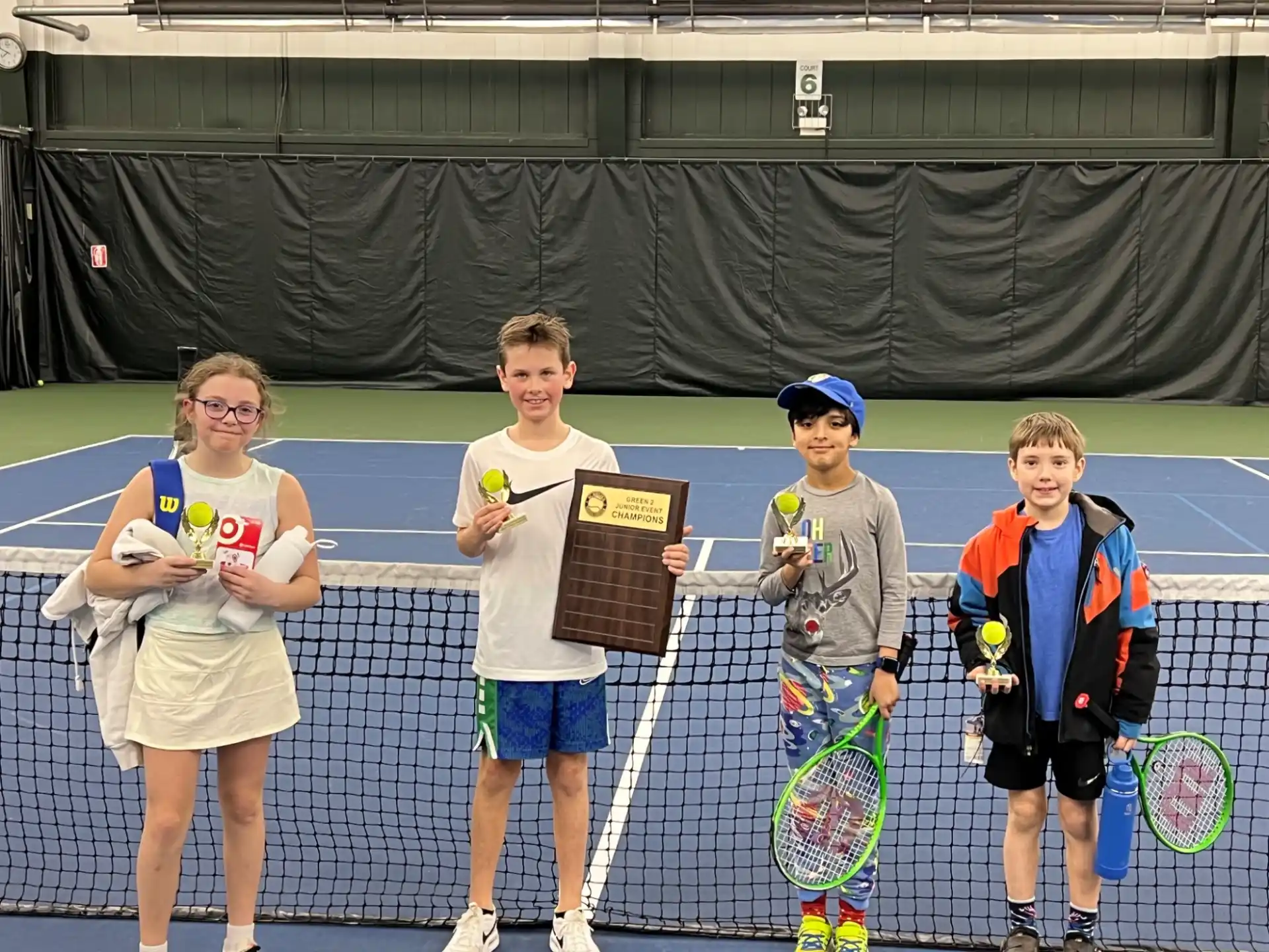 a group of people holding tennis rackets
