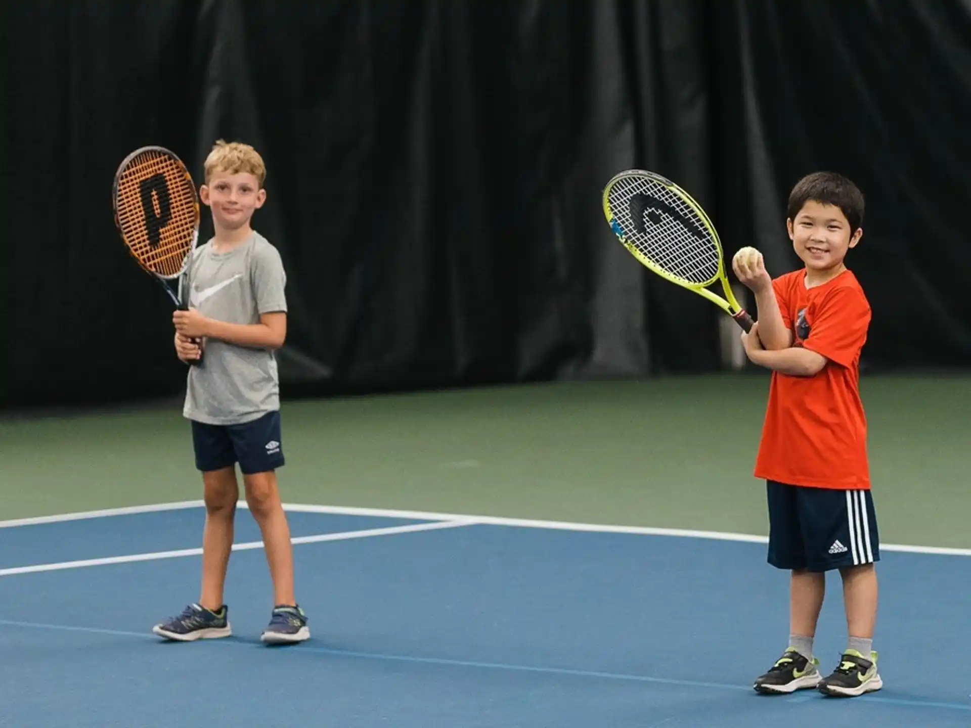 kids holding tennis rackets