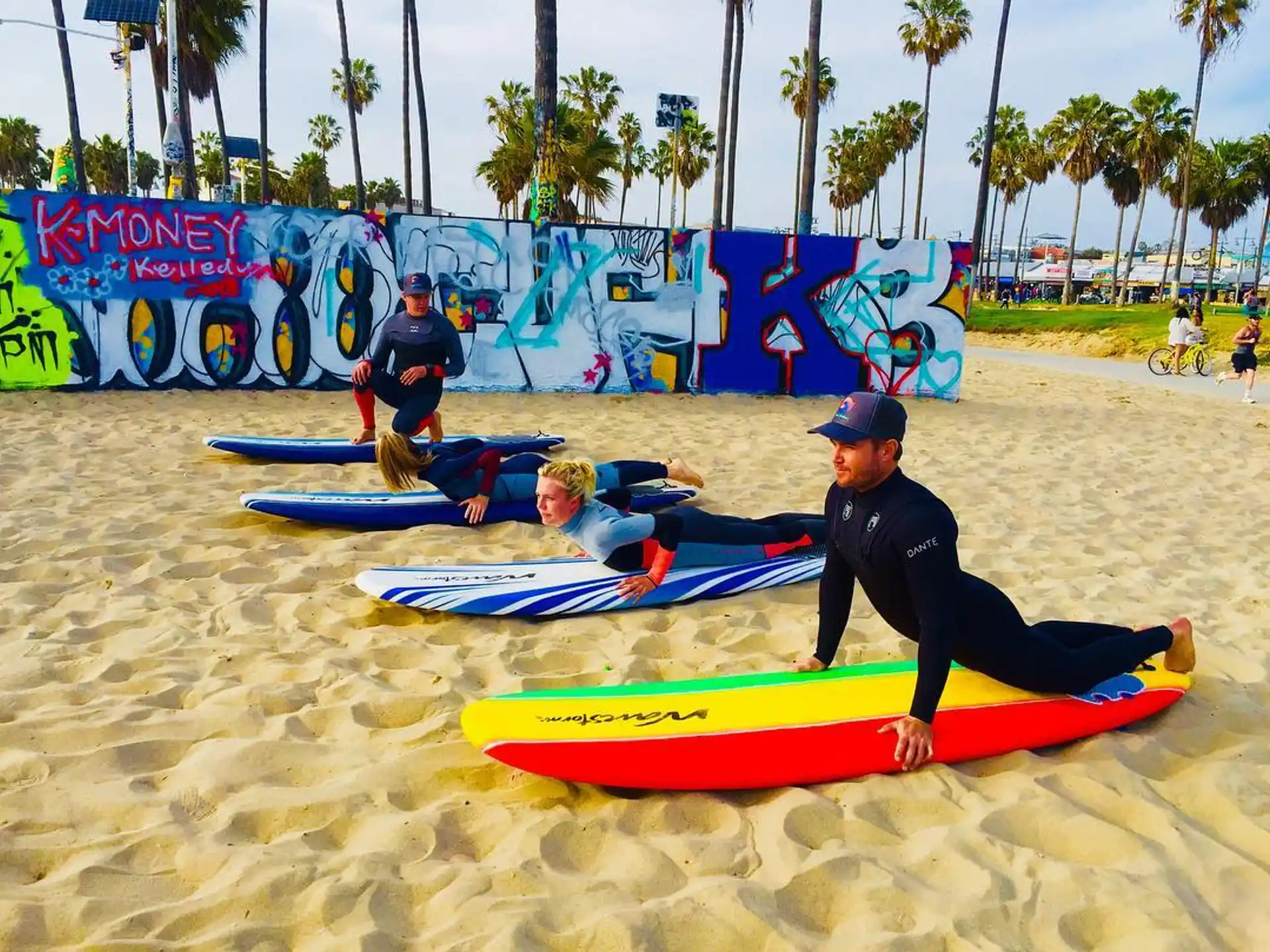 a group of surfers on the beach