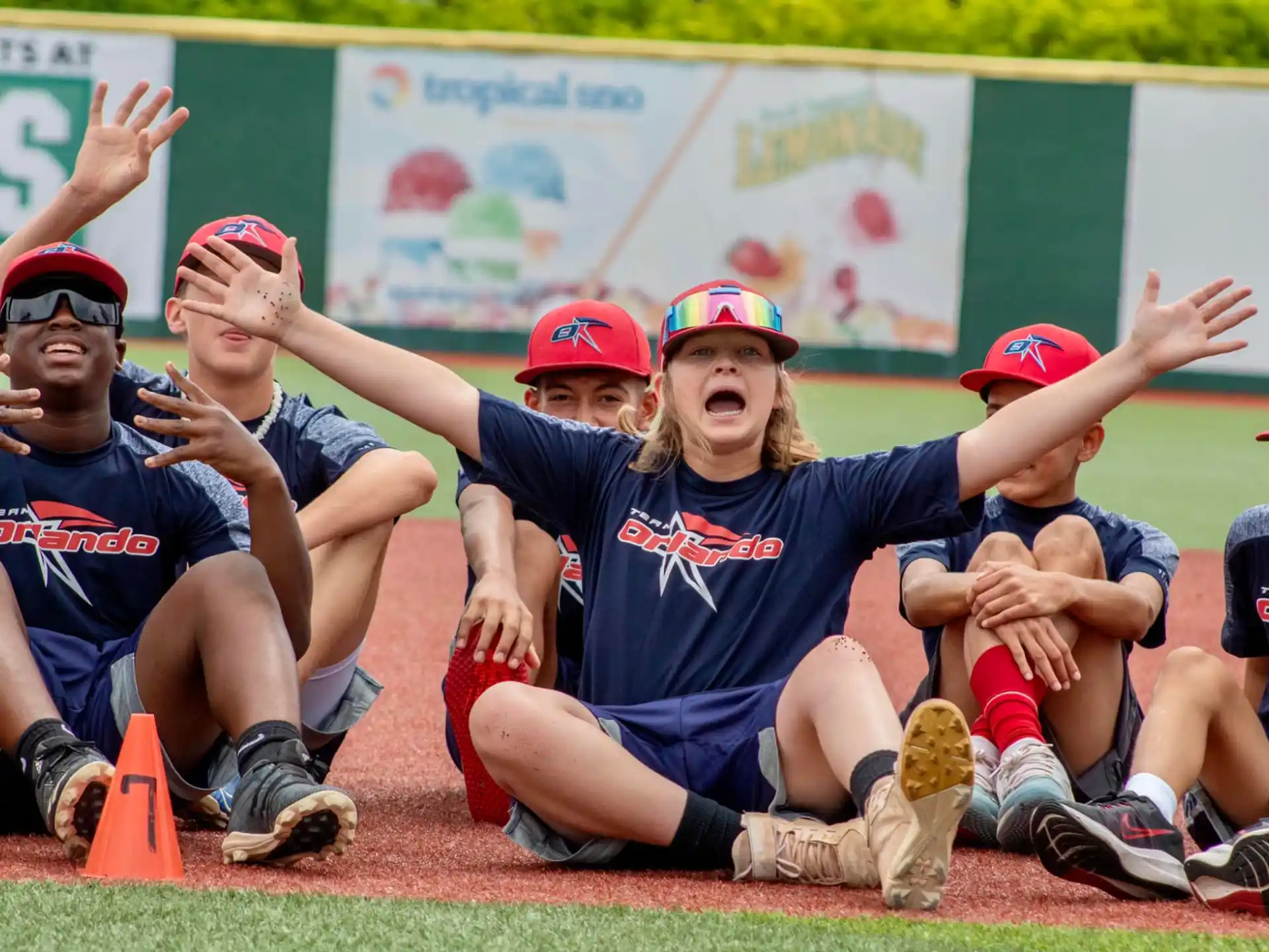 a group of people kneeling on the ground with their hands up