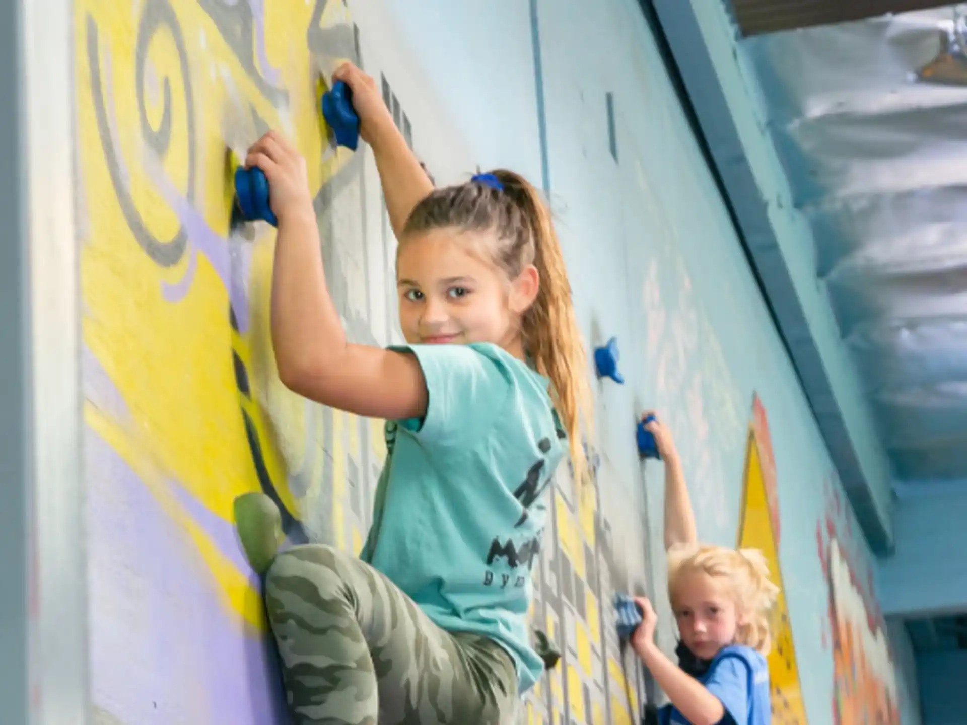 a girl climbing a wall