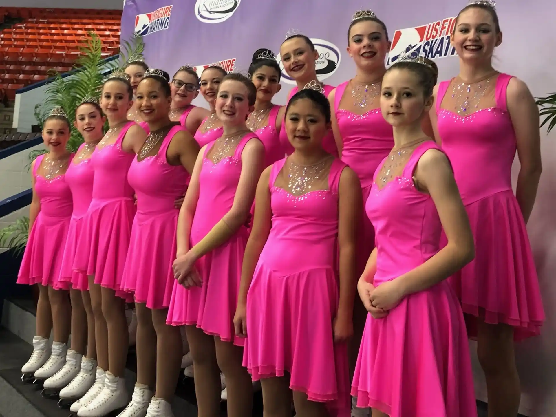 a group of women in pink dresses