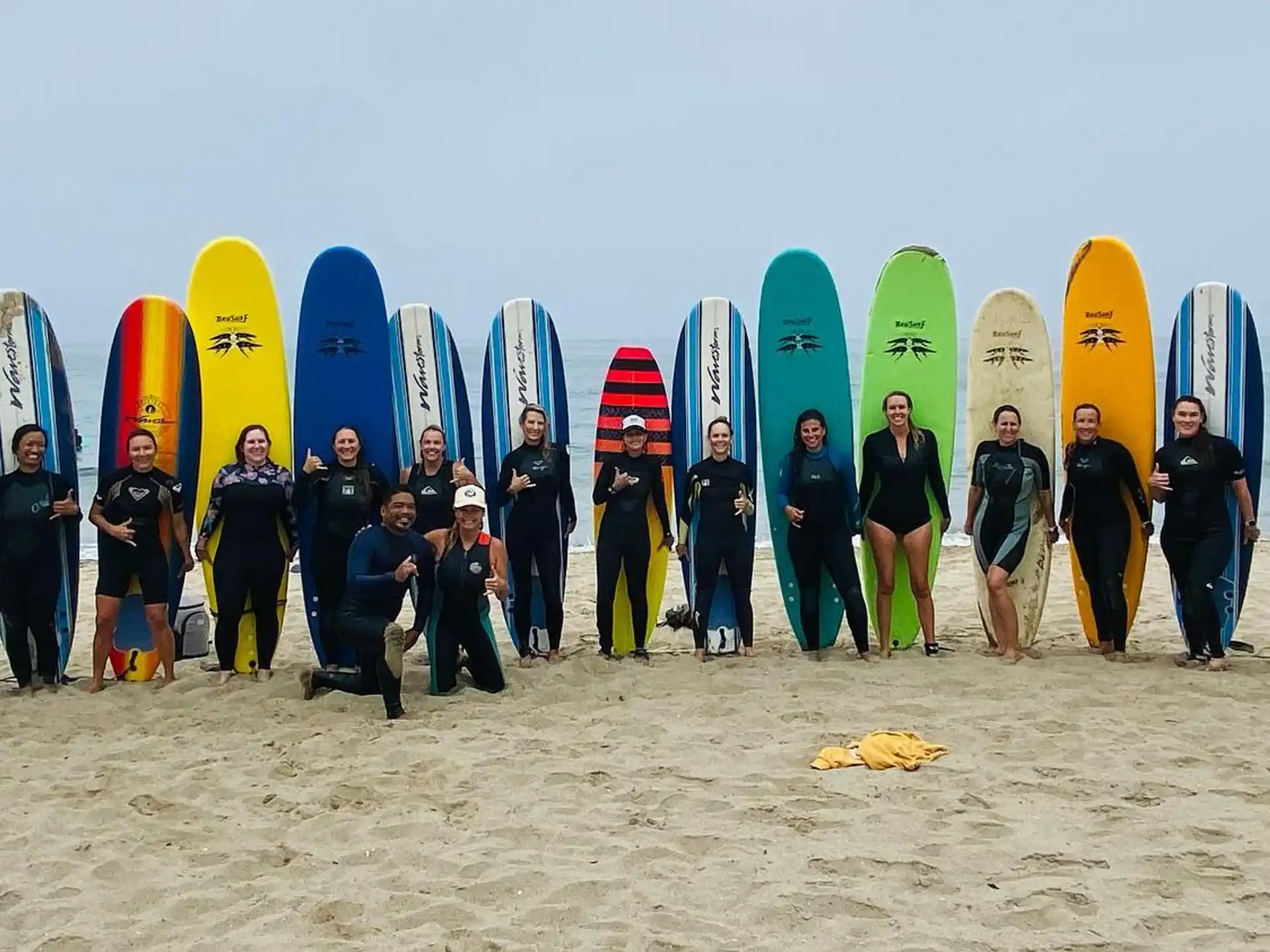 a group of surfers pose for a photo
