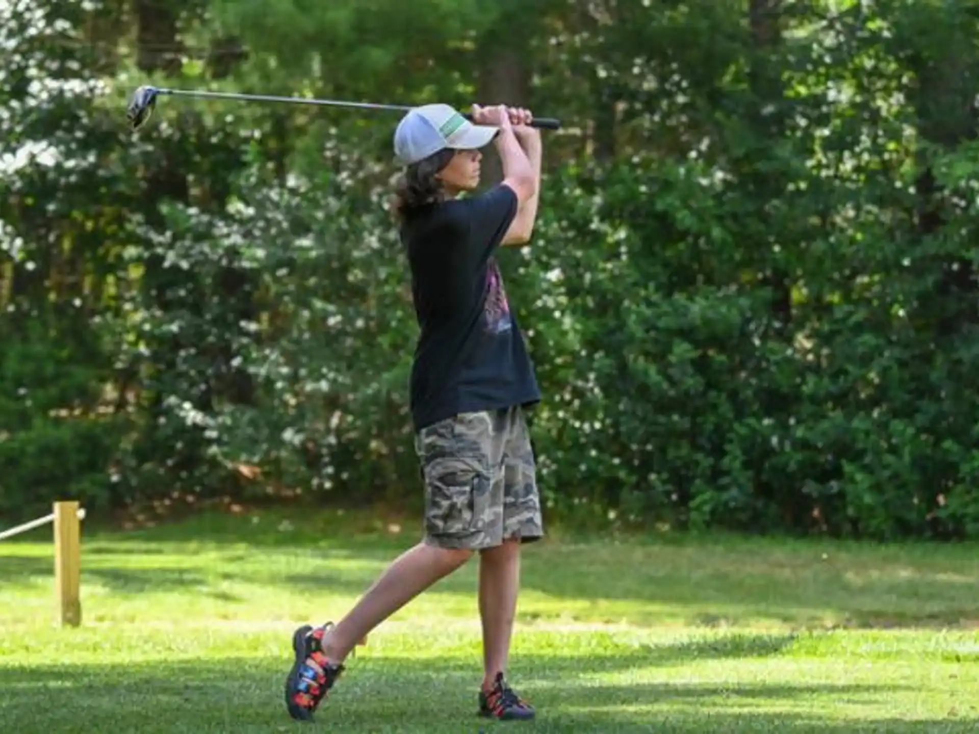 a person swinging a golf club