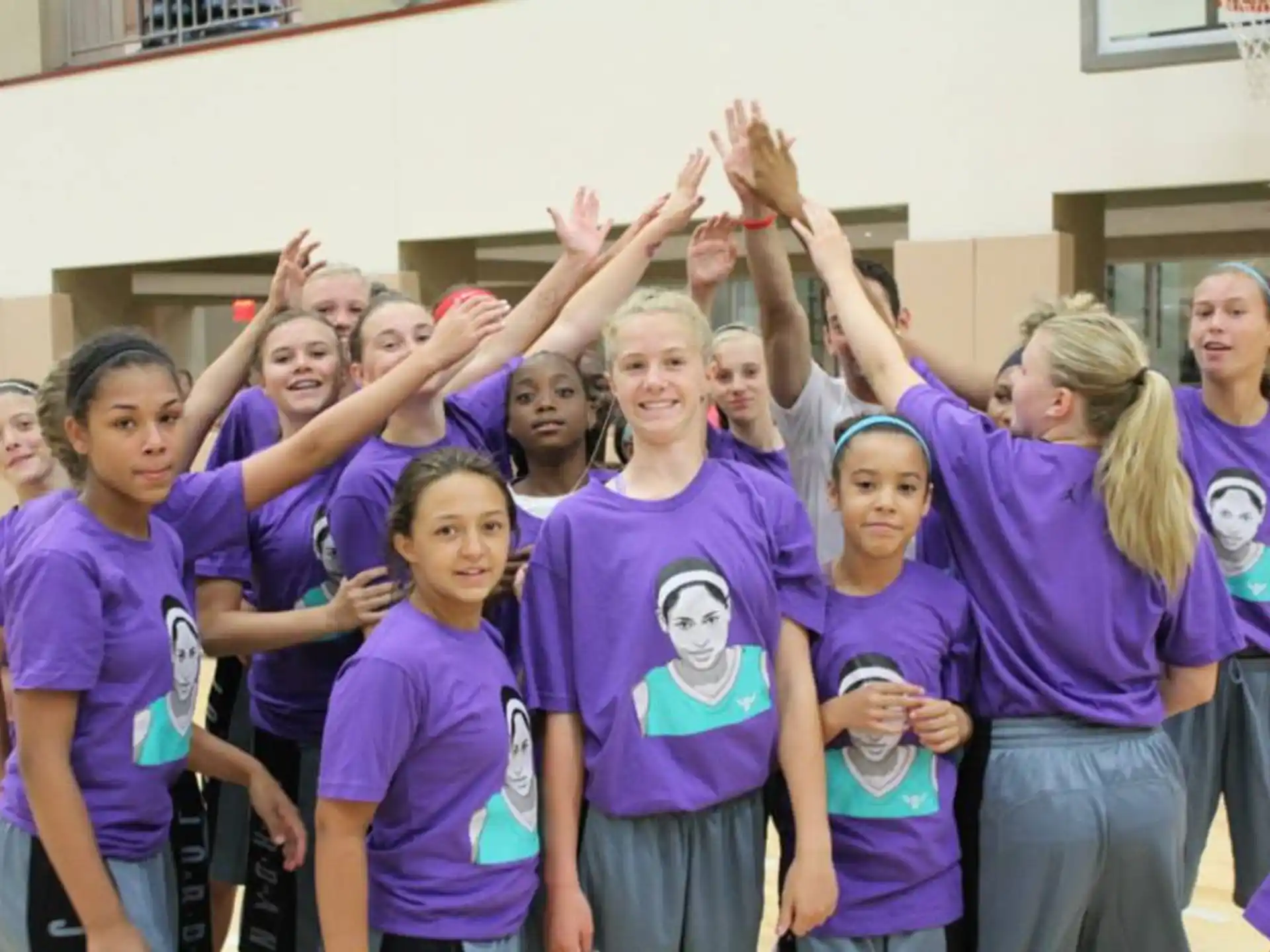 a group of girls in purple shirts