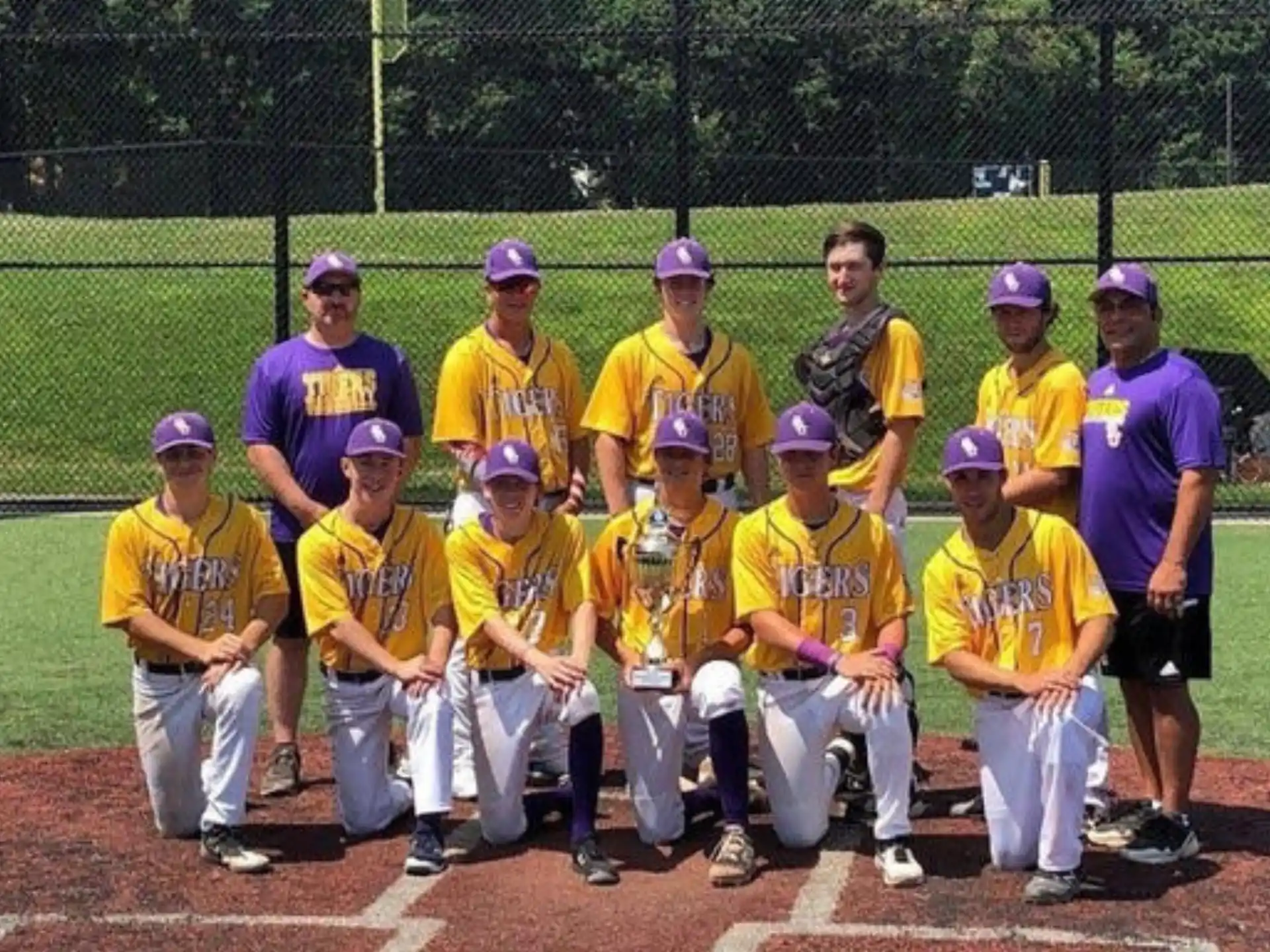 a group of baseball players pose for a photo