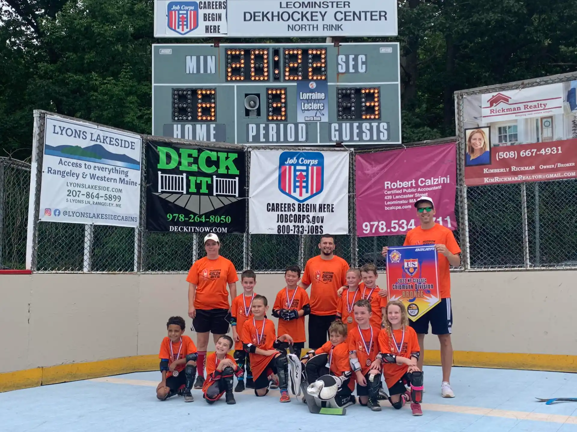 a group of people wearing orange shirts