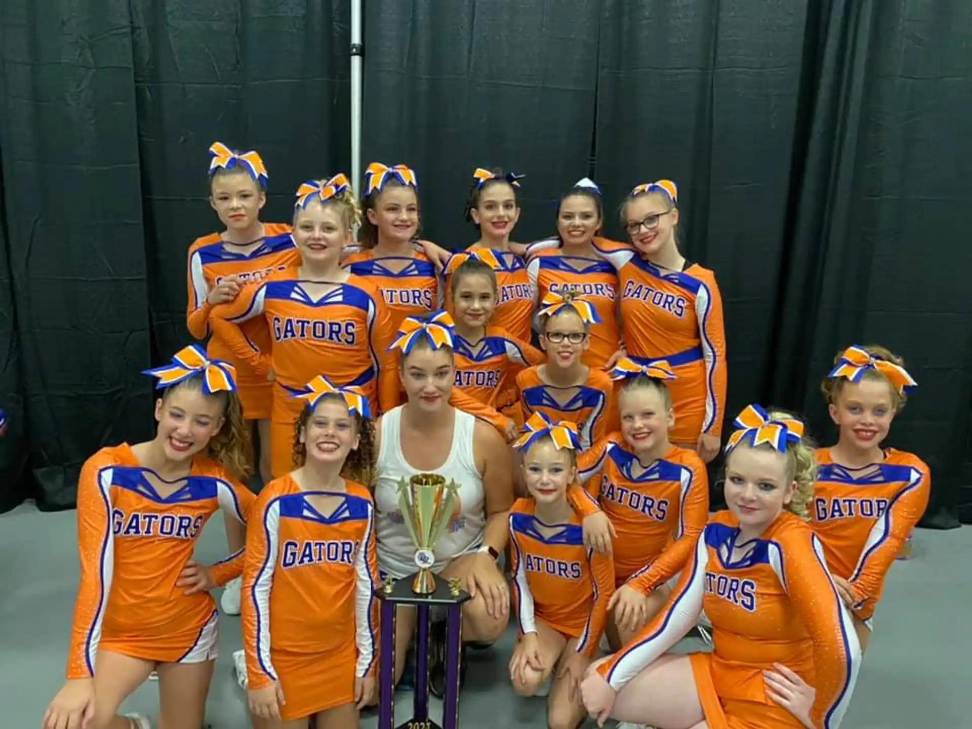 a group of girls in orange and blue uniforms