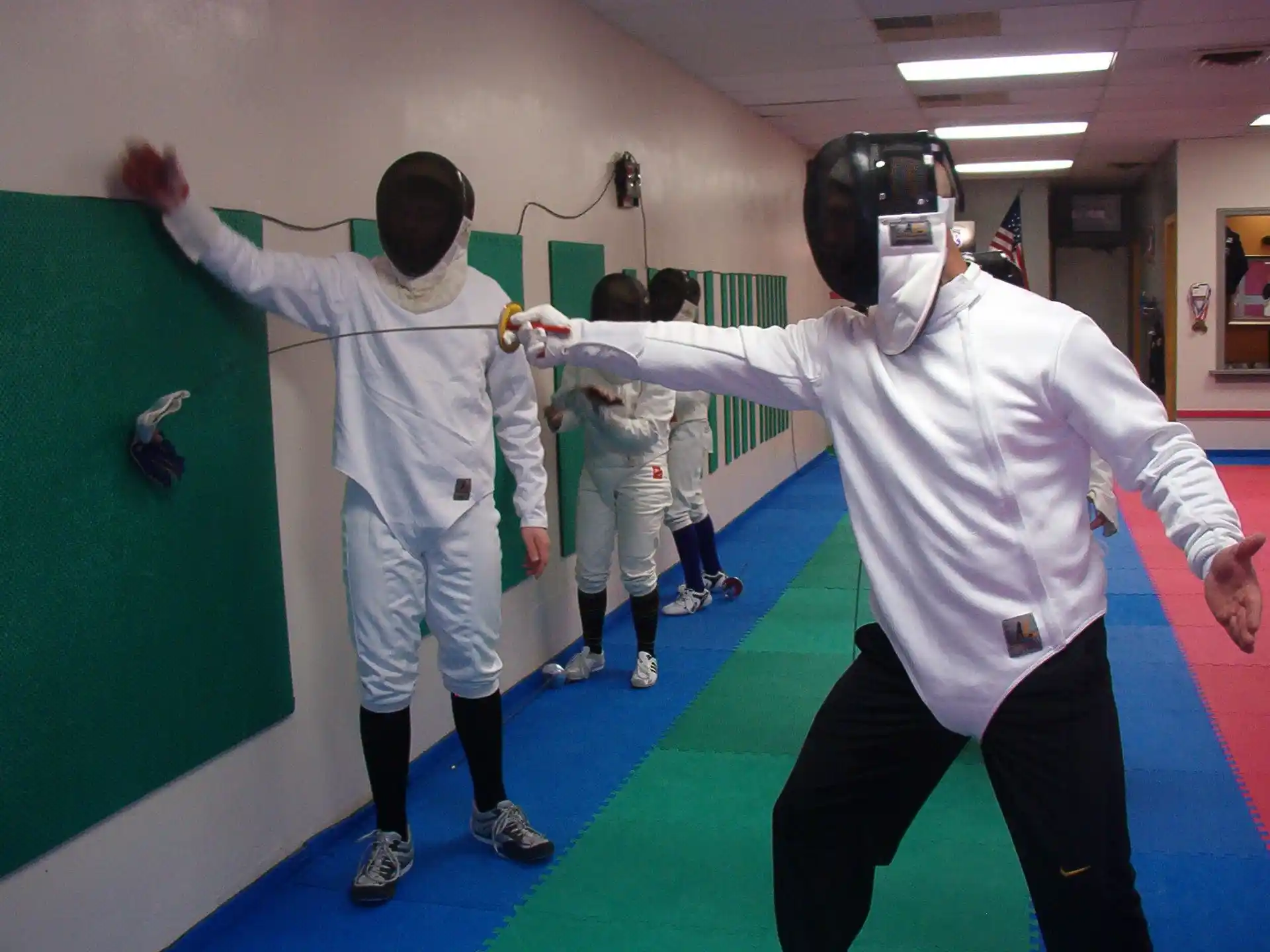 a group of people in white karate uniforms in a room