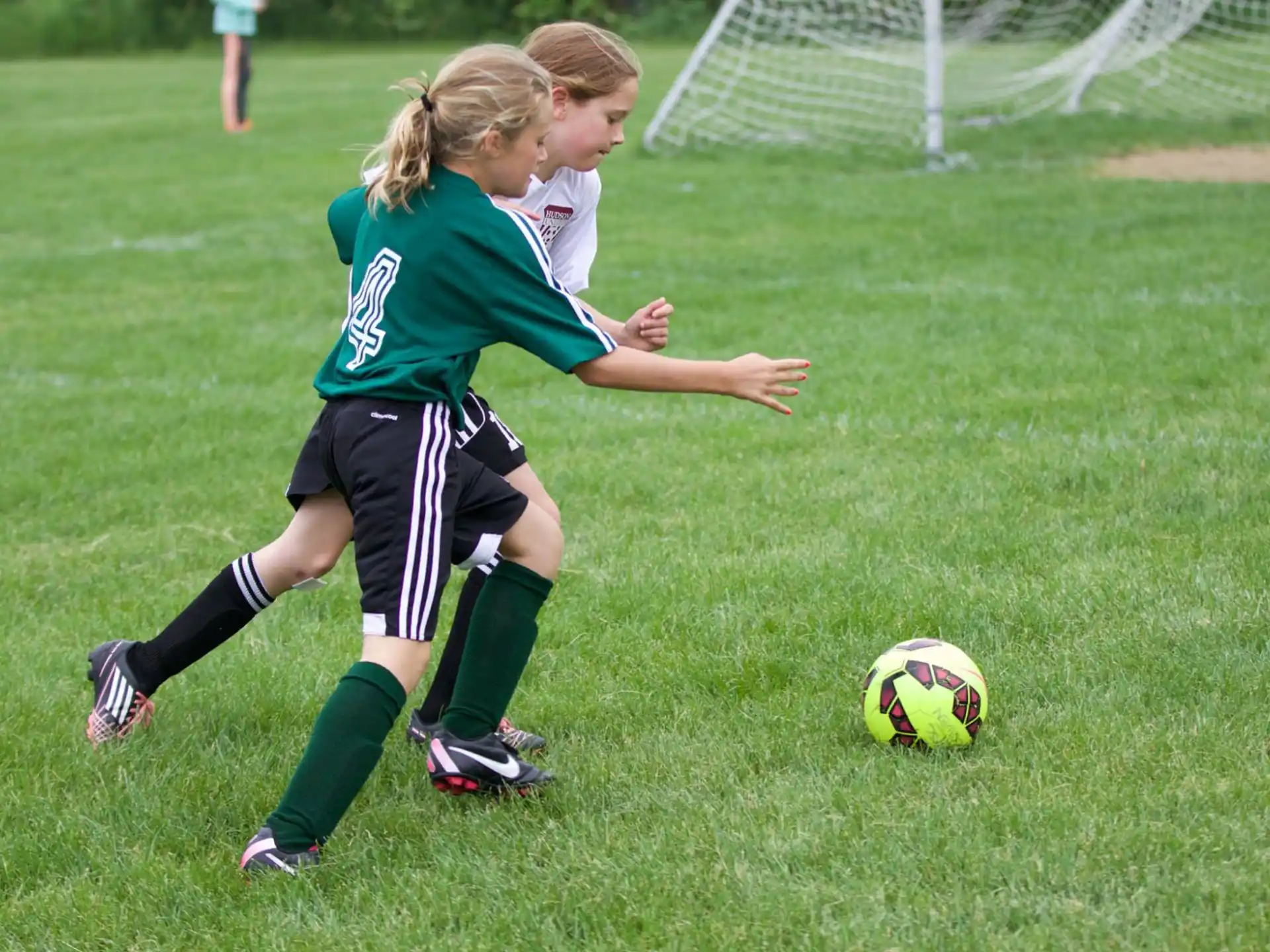 girls playing football on a field