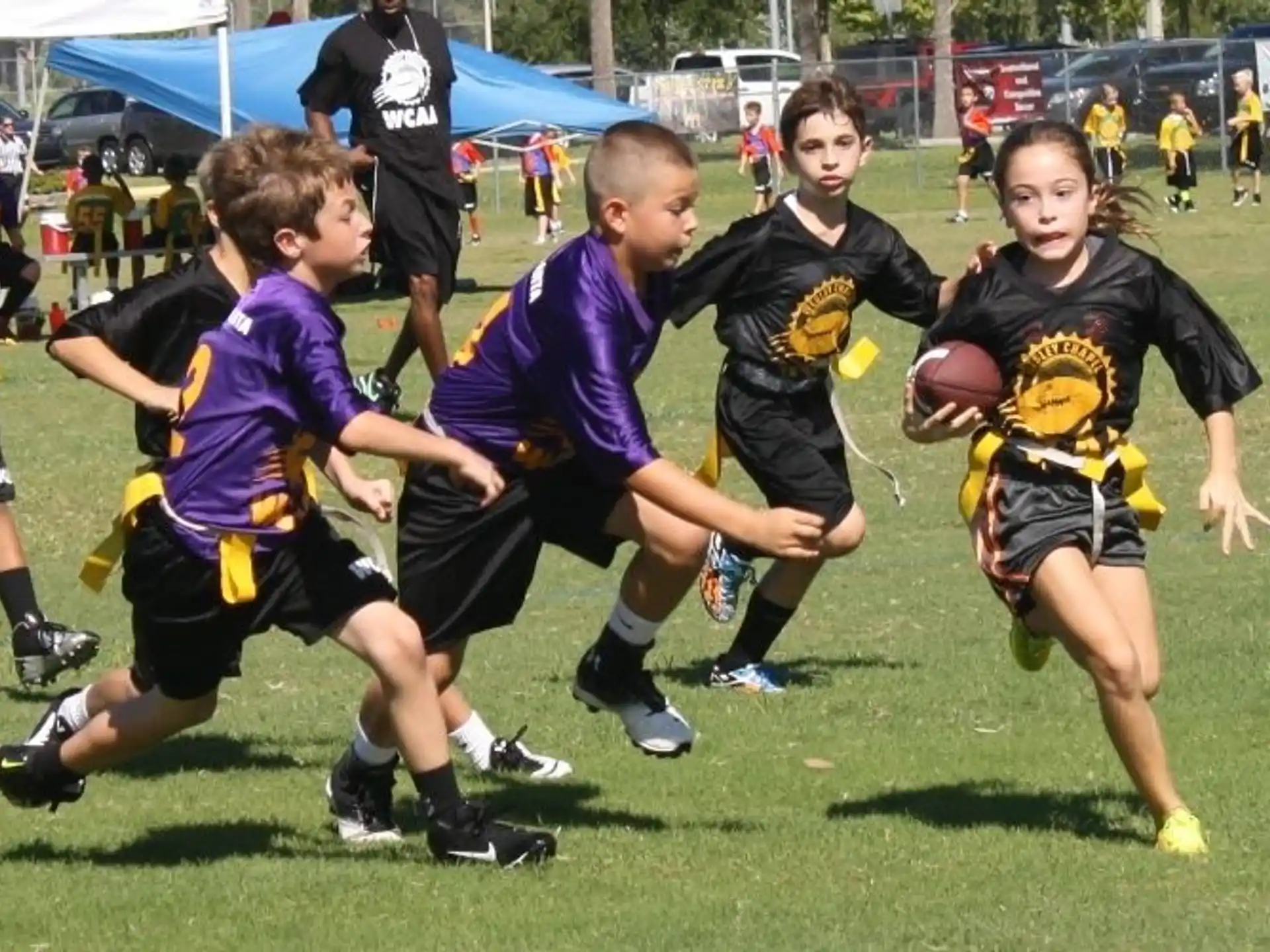 a group of kids playing football