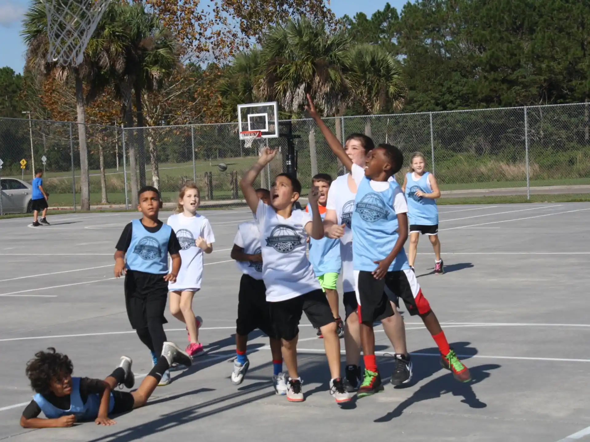 a group of people playing basketball