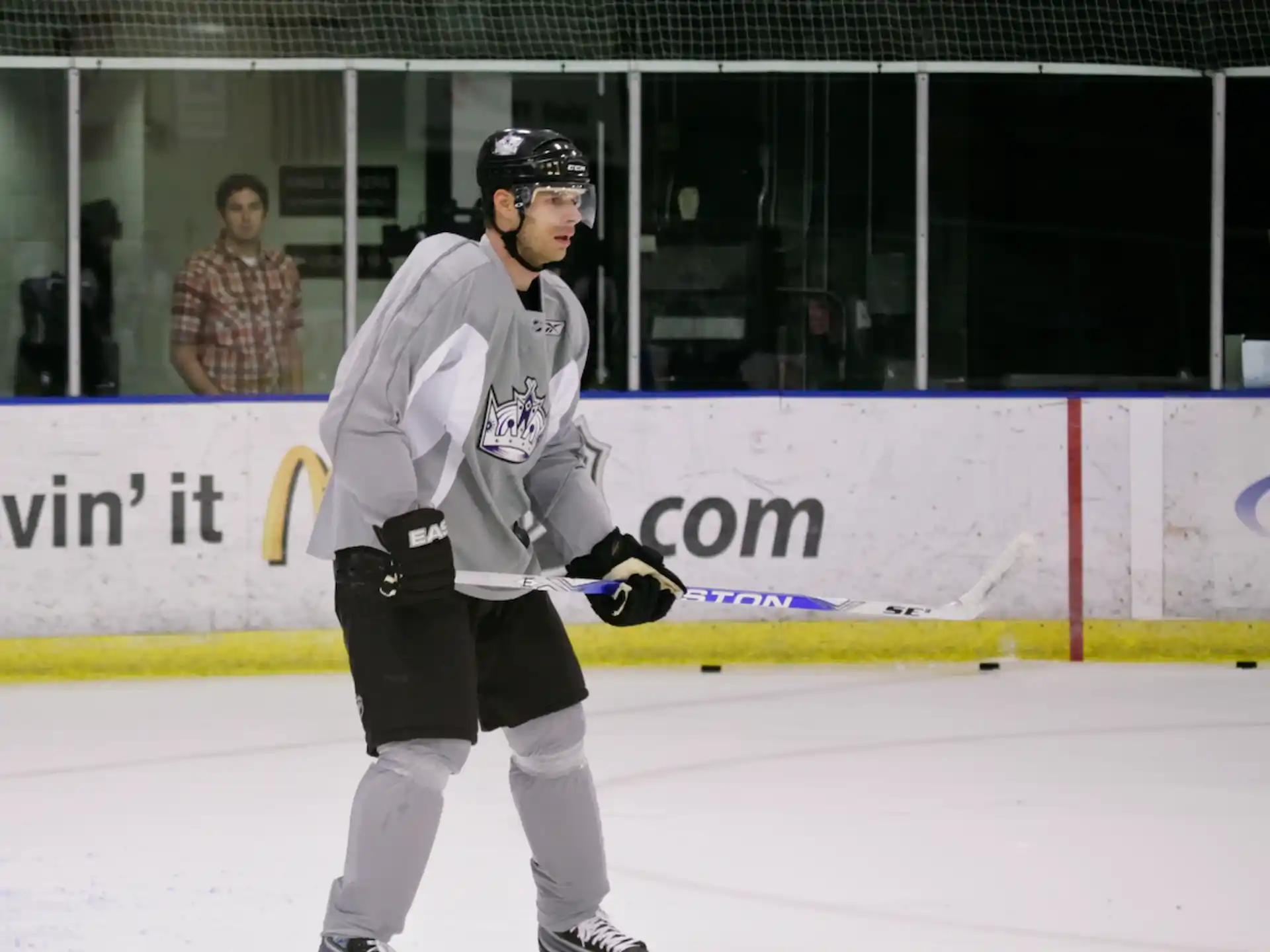 a person wearing a hockey uniform and helmet on ice