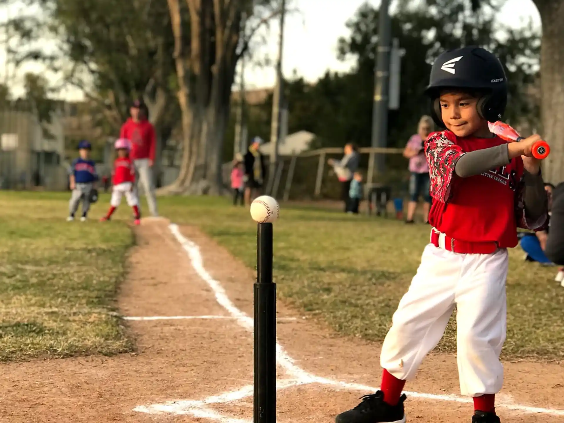 a kid swinging a baseball bat
