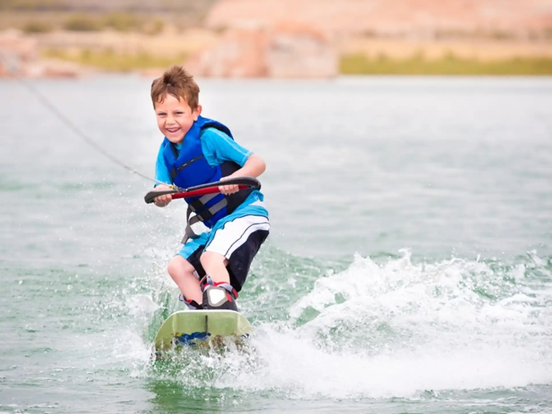 a boy kite surfing on the sea