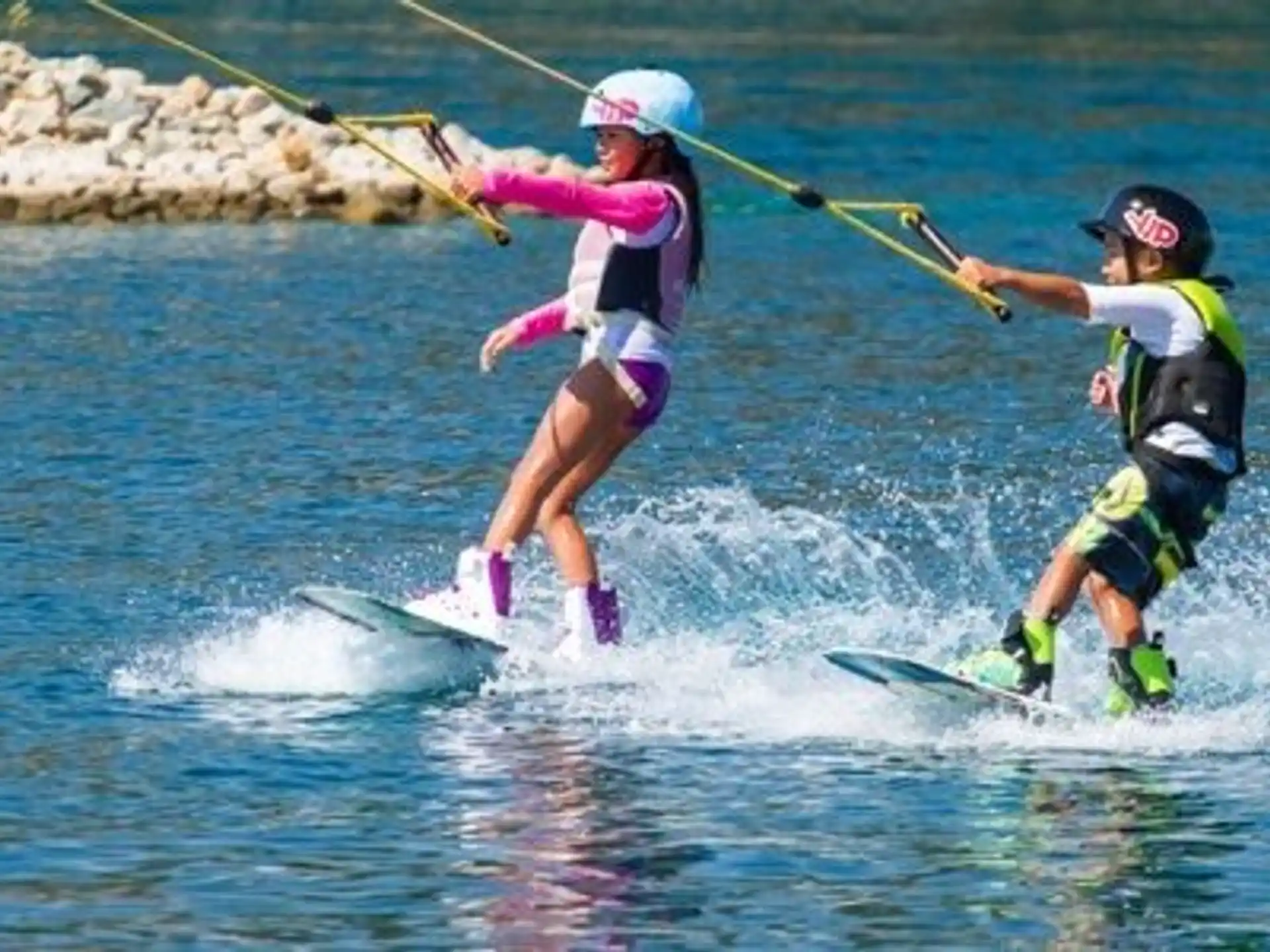 a couple of people water skiing