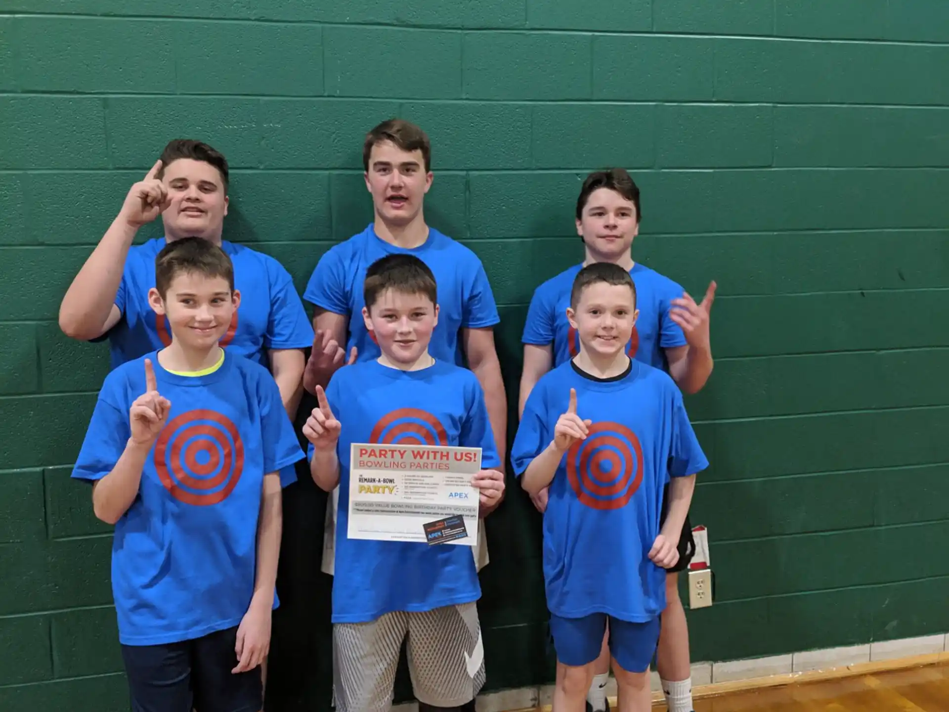 a group of boys in blue shirts