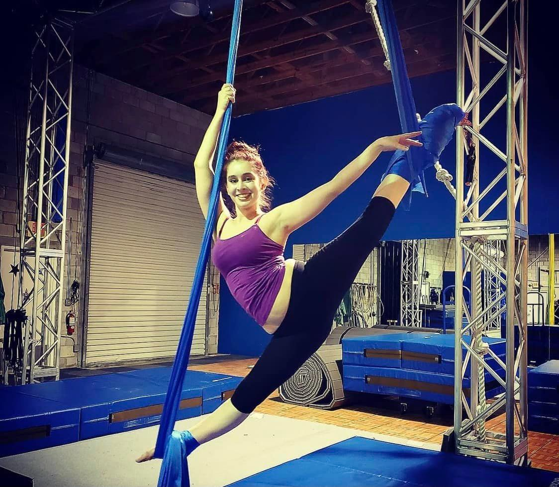 a person doing a handstand on a bar