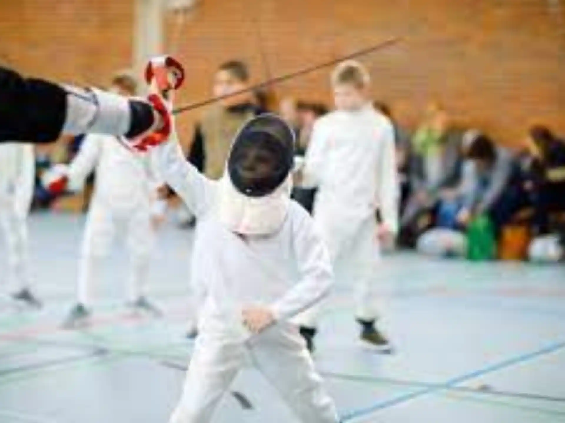 a group of people in white karate uniforms