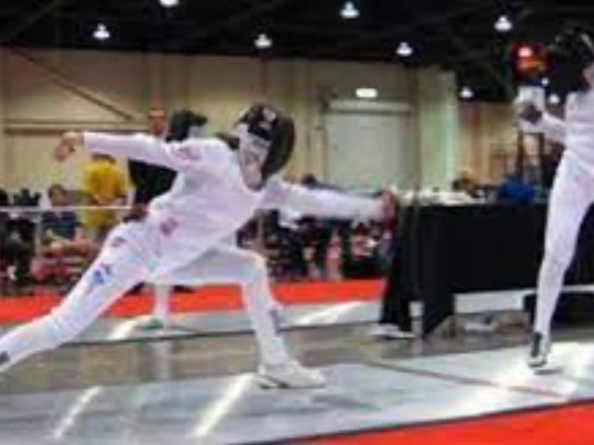 a group of people in white uniforms in a martial arts ring