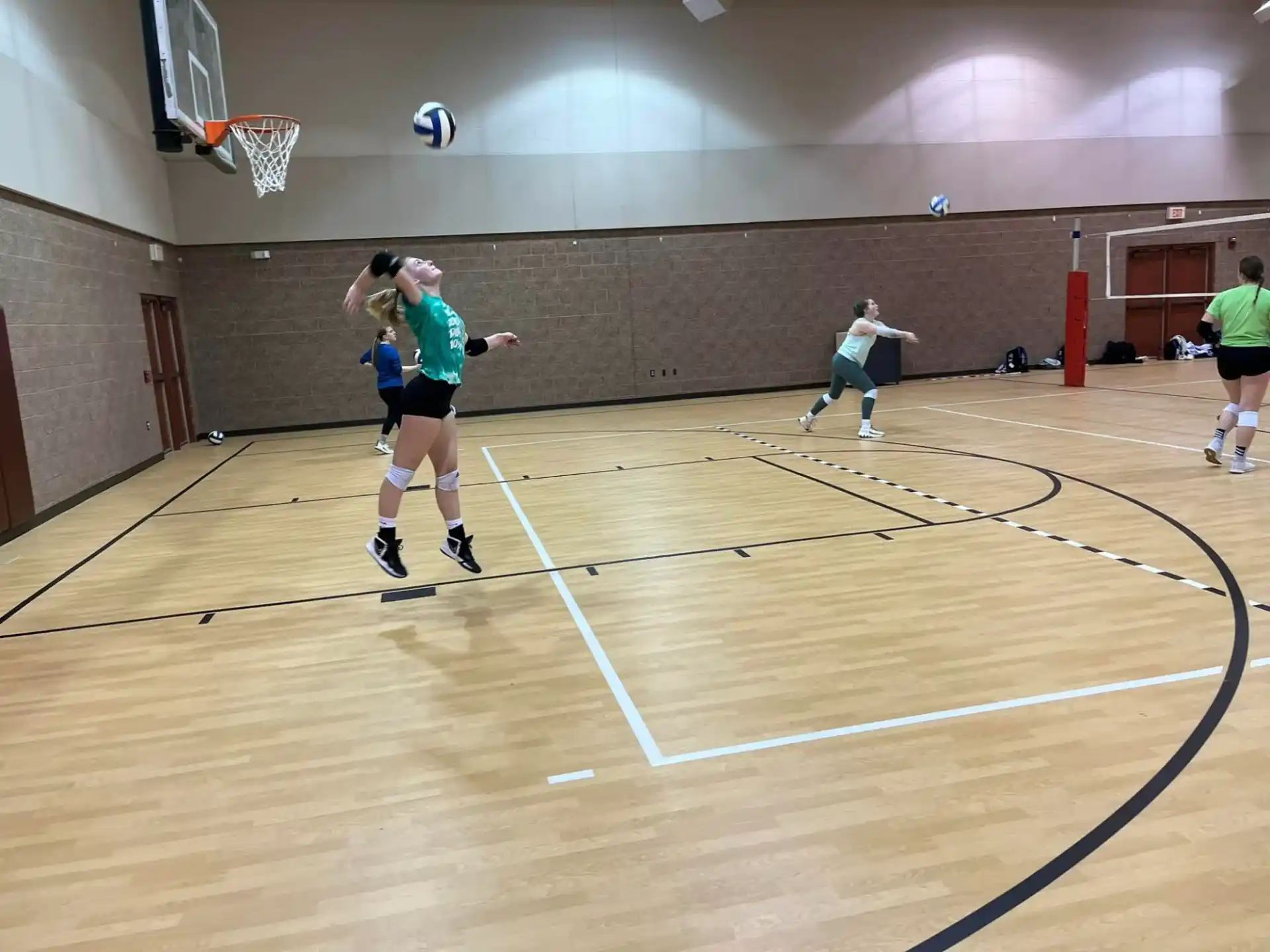 a group of people playing volleyball