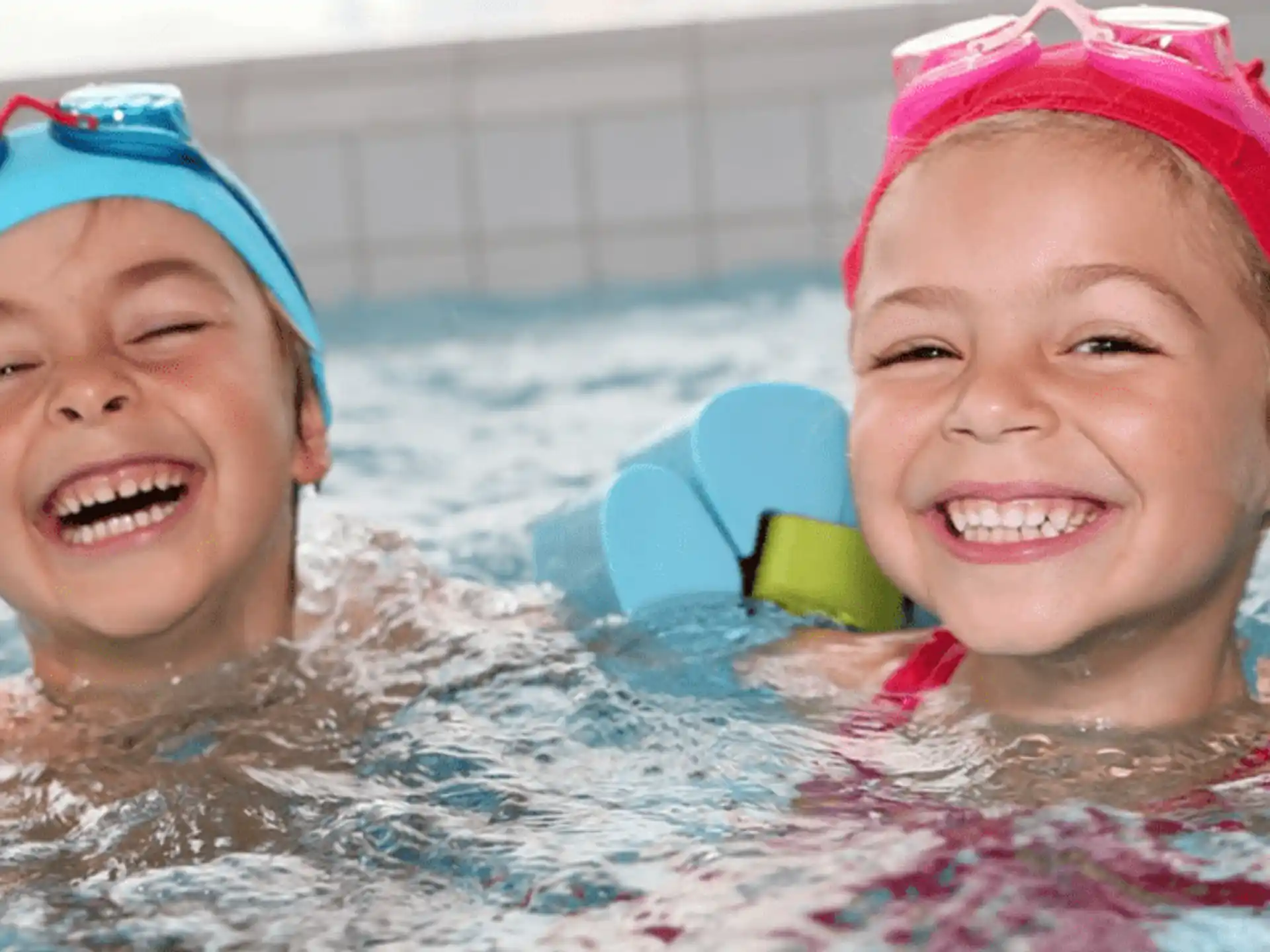 a couple of children in a pool