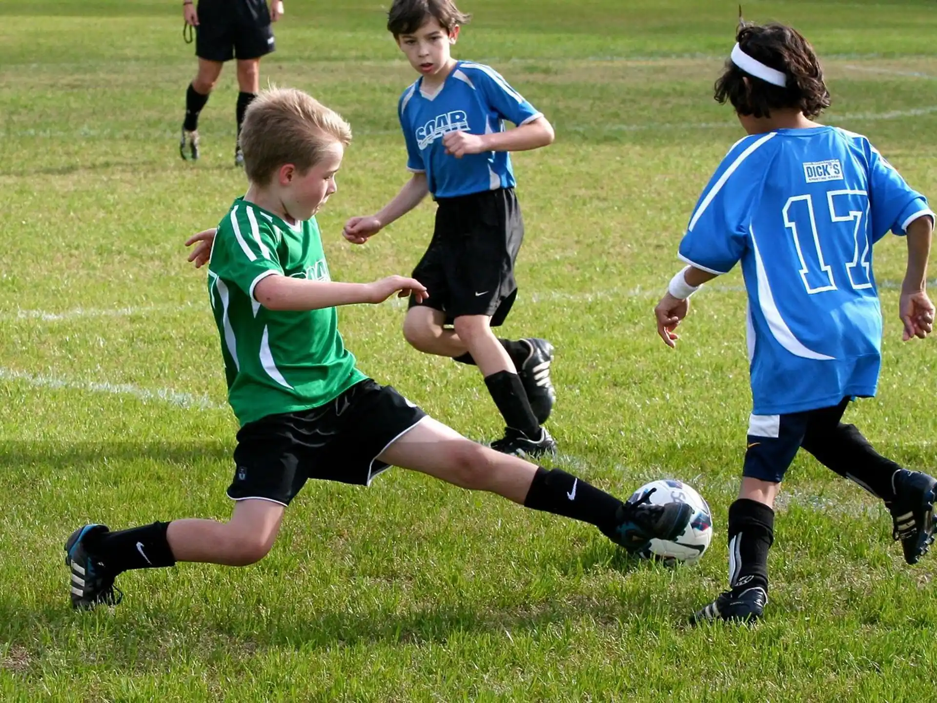 kids playing football on a field