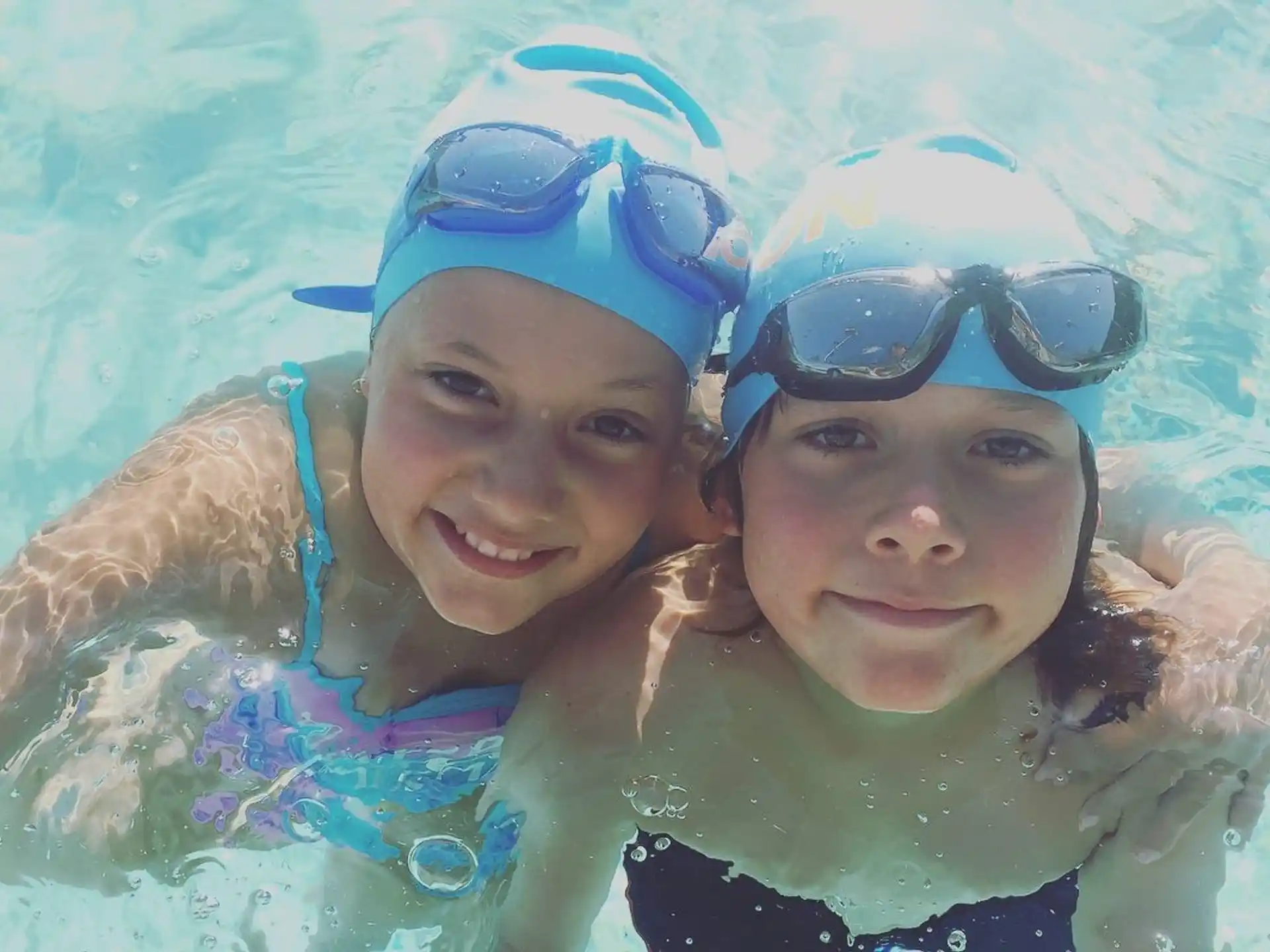 a couple of girls in a pool