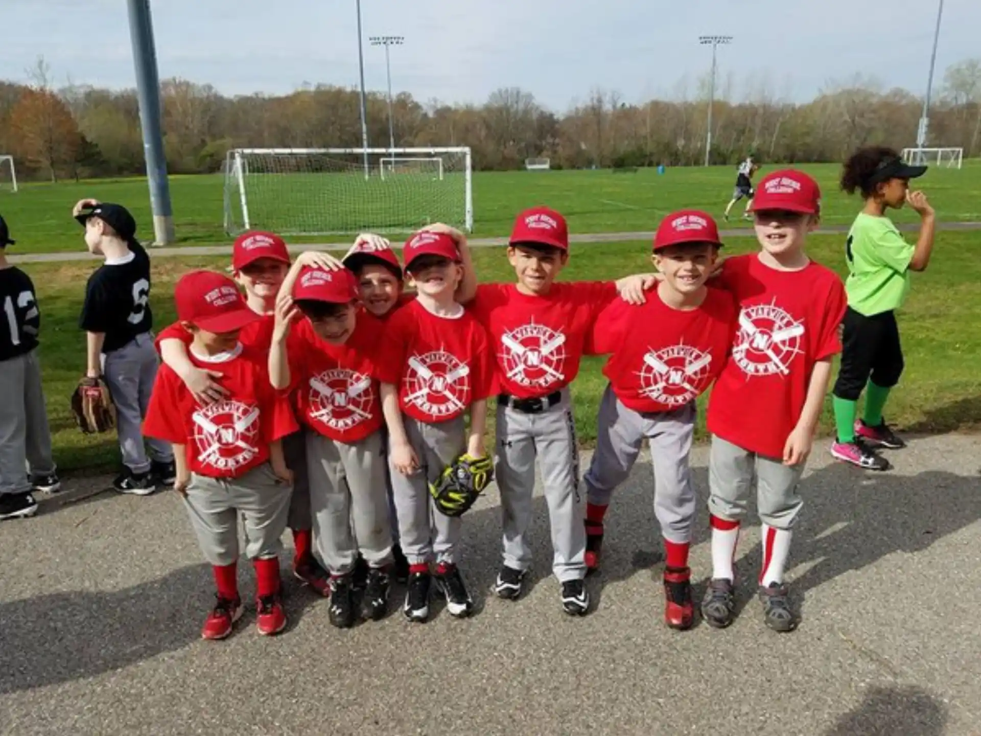 a group of kids in baseball uniforms