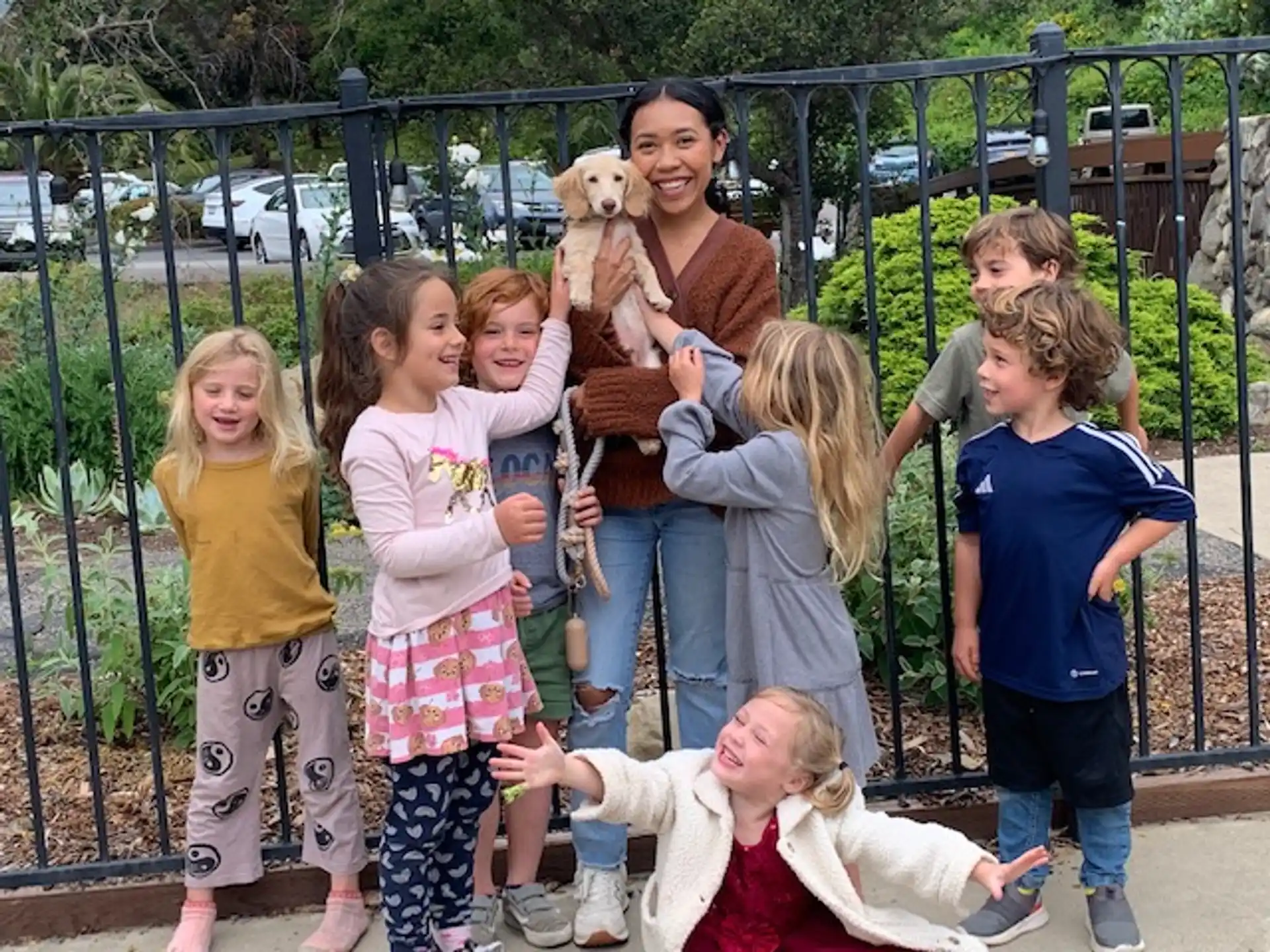 a group of children holding a dog