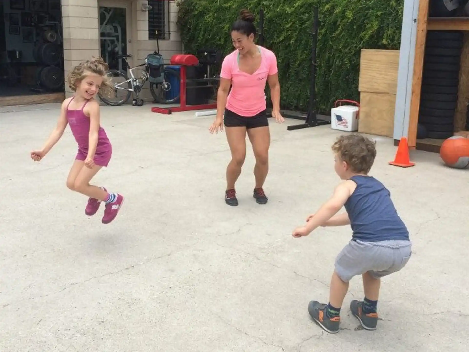 a person and two children playing outside