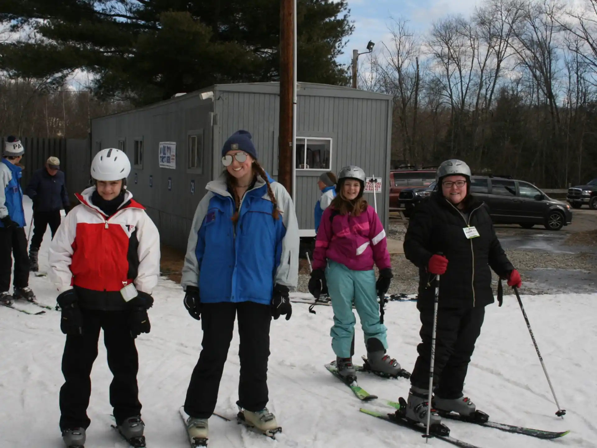 a group of people pose for a picture on snow skis
