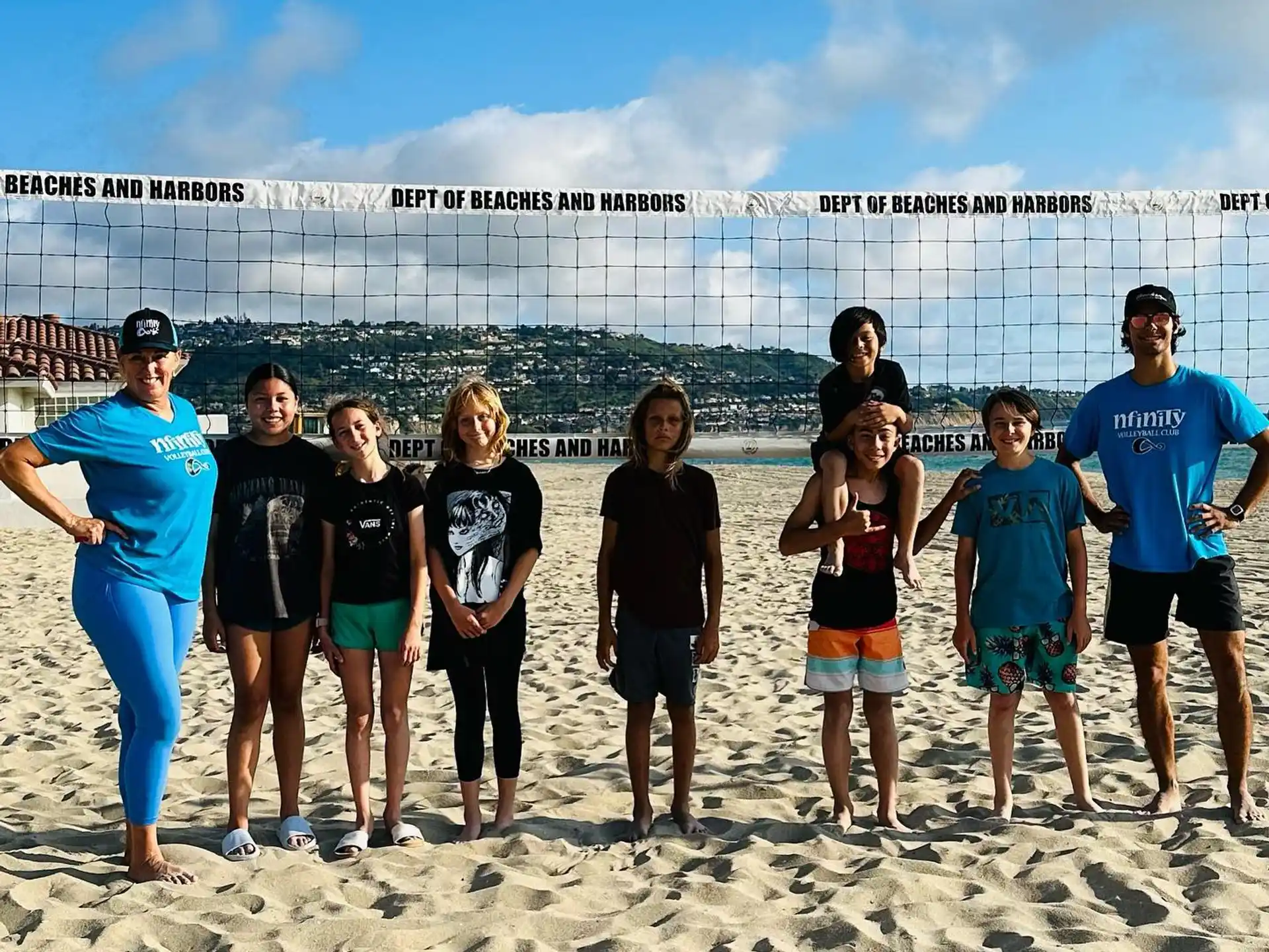 a group of people posing for a photo on a beach