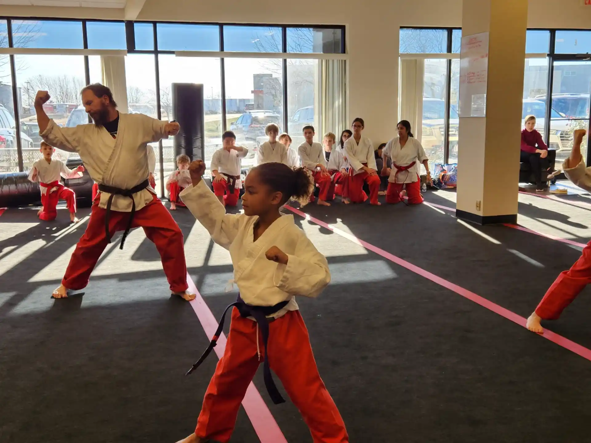 a boy and girl in karate uniforms