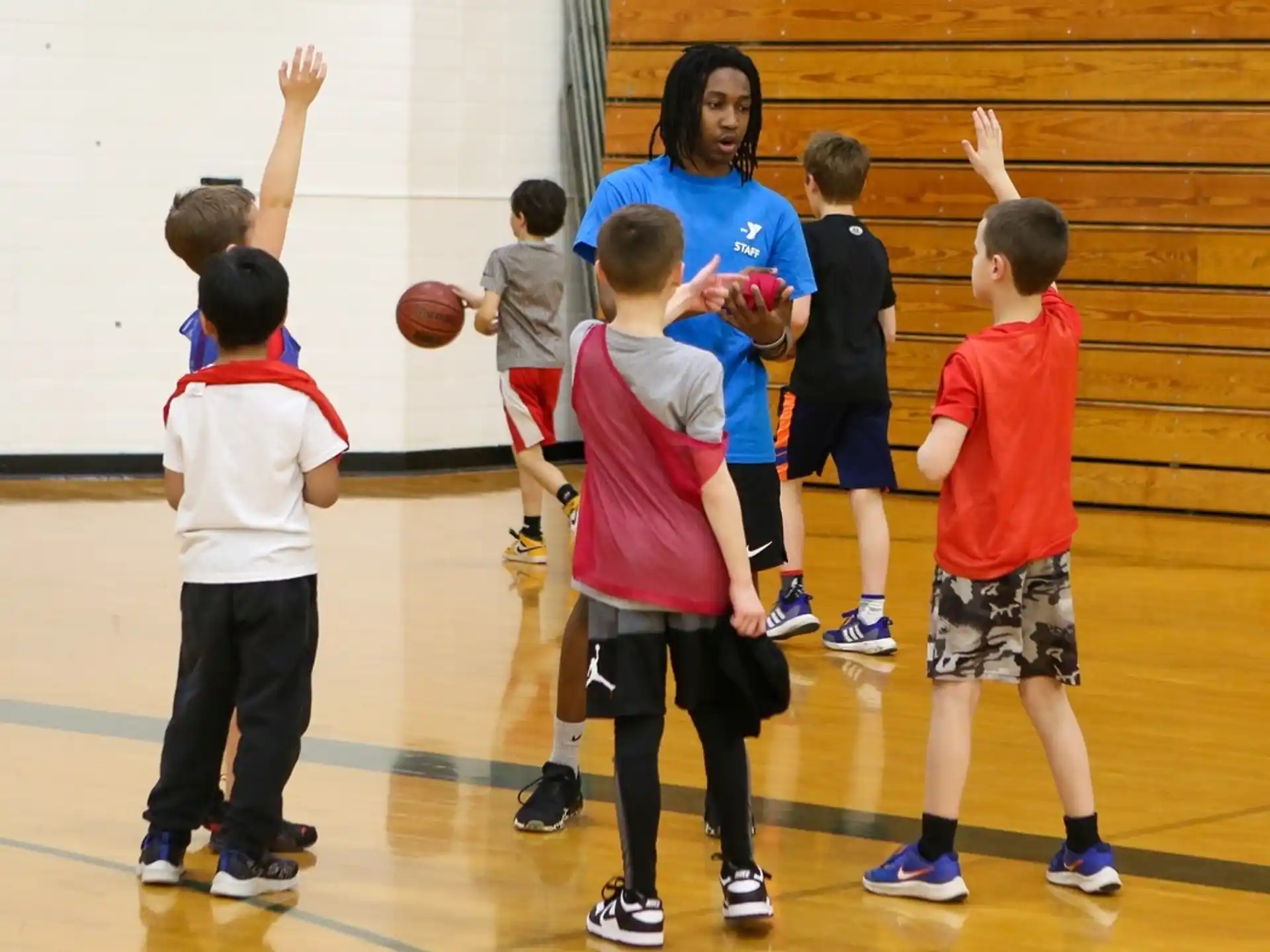 a group of kids playing basketball